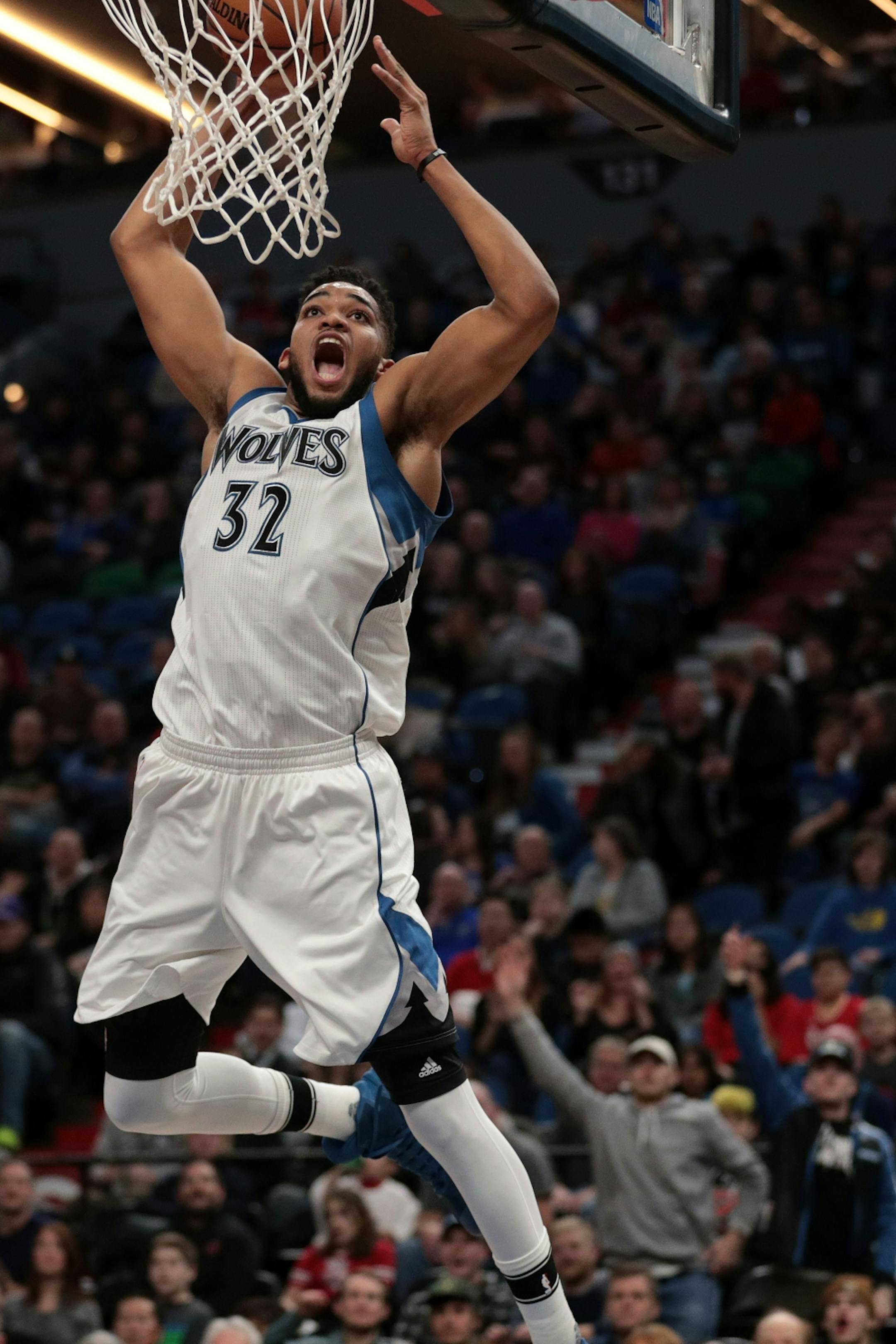 Minnesota Timberwolves center Karl-Anthony Towns (32) dunks the ball in the first half.