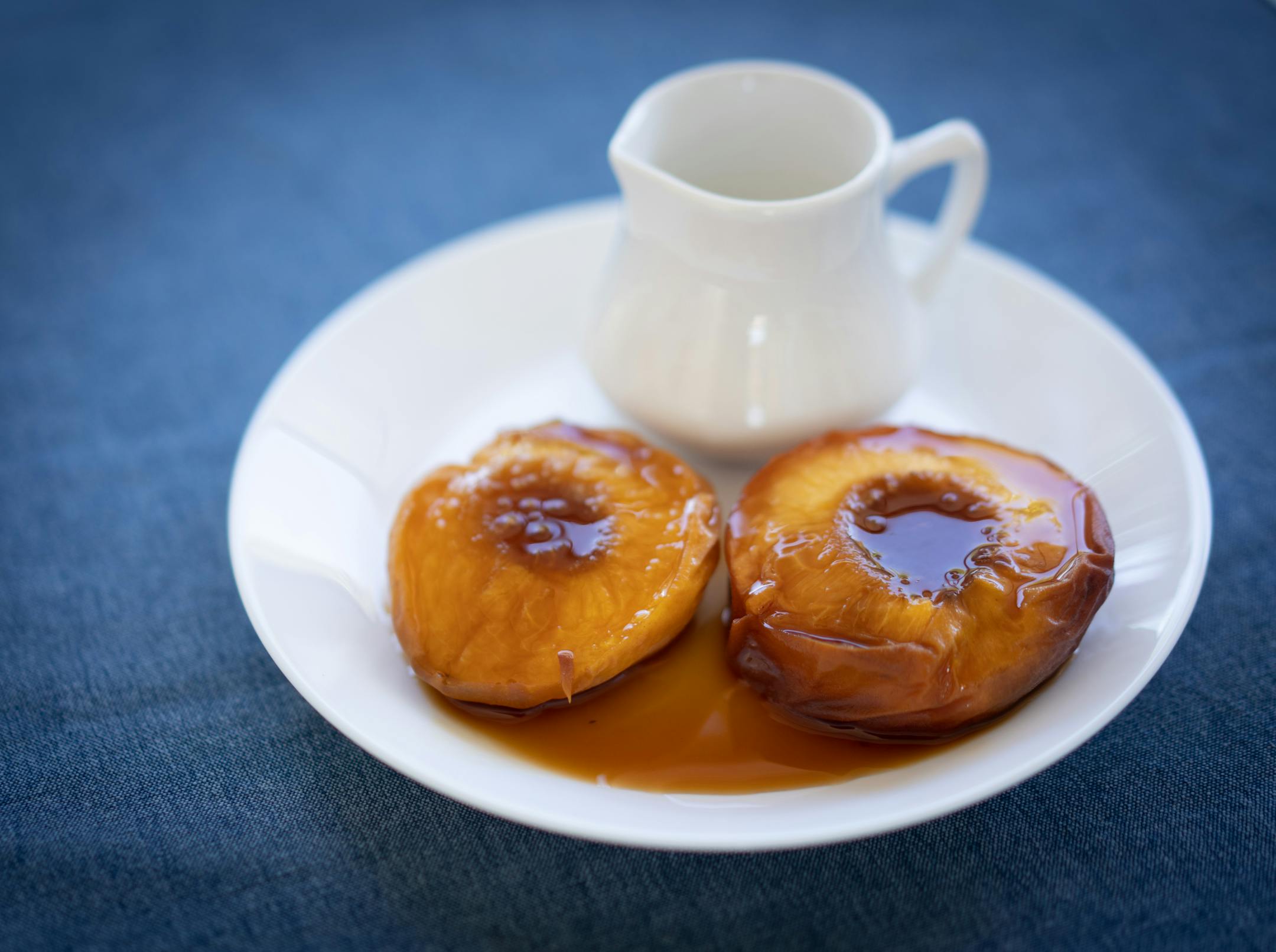 Peaches roasted with marsala and brown sugar served with luscious pouring cream at Gia at the Lake.