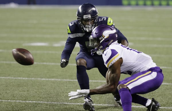 Seattle Seahawks cornerback Tramaine Brock (5) defends as Minnesota Vikings wide receiver Rodney Adams, right, makes a low catch in the second half of