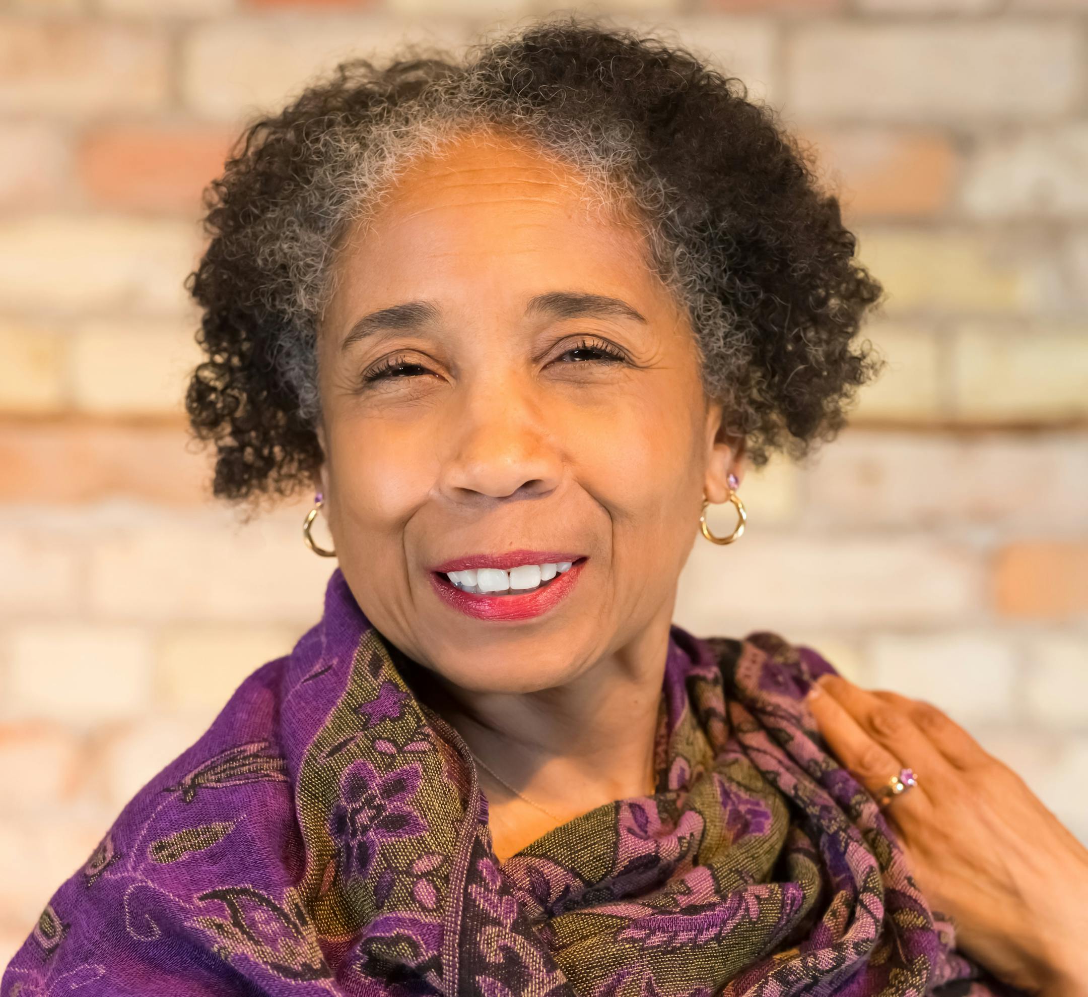 photo of author Debra J. Stone in a purple scarf