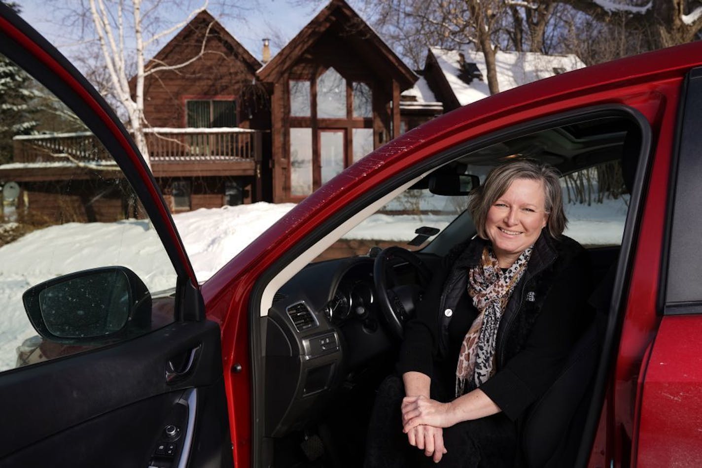 Debbie Donovan, who spends mornings working as a Lyft driver (and loves it) after leaving a technology job, sat for a portrait with her car Tuesday.