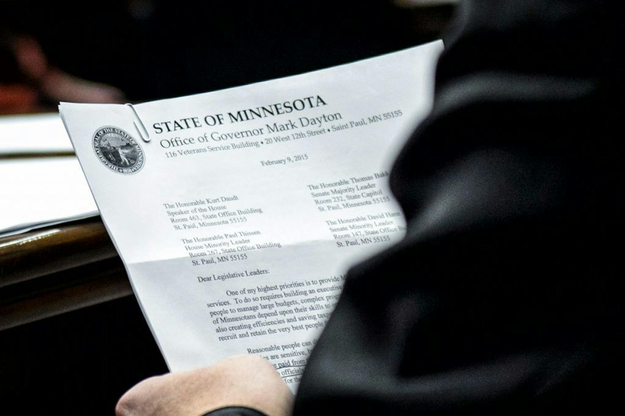 Representative Steve Drazkowski read from Governor Dayton's letter explaining commissioner pay raises as he questioned Minnesota Management and Budget Commissioner Myron Frans at the House Ways and Means Committee hearing about Governor Dayton's raises for commissioners. The committee approved Drazkowski's amendment that would reduce deficiency funding for state agencies by the amount of the raises approved for the commissioners of those agencies.