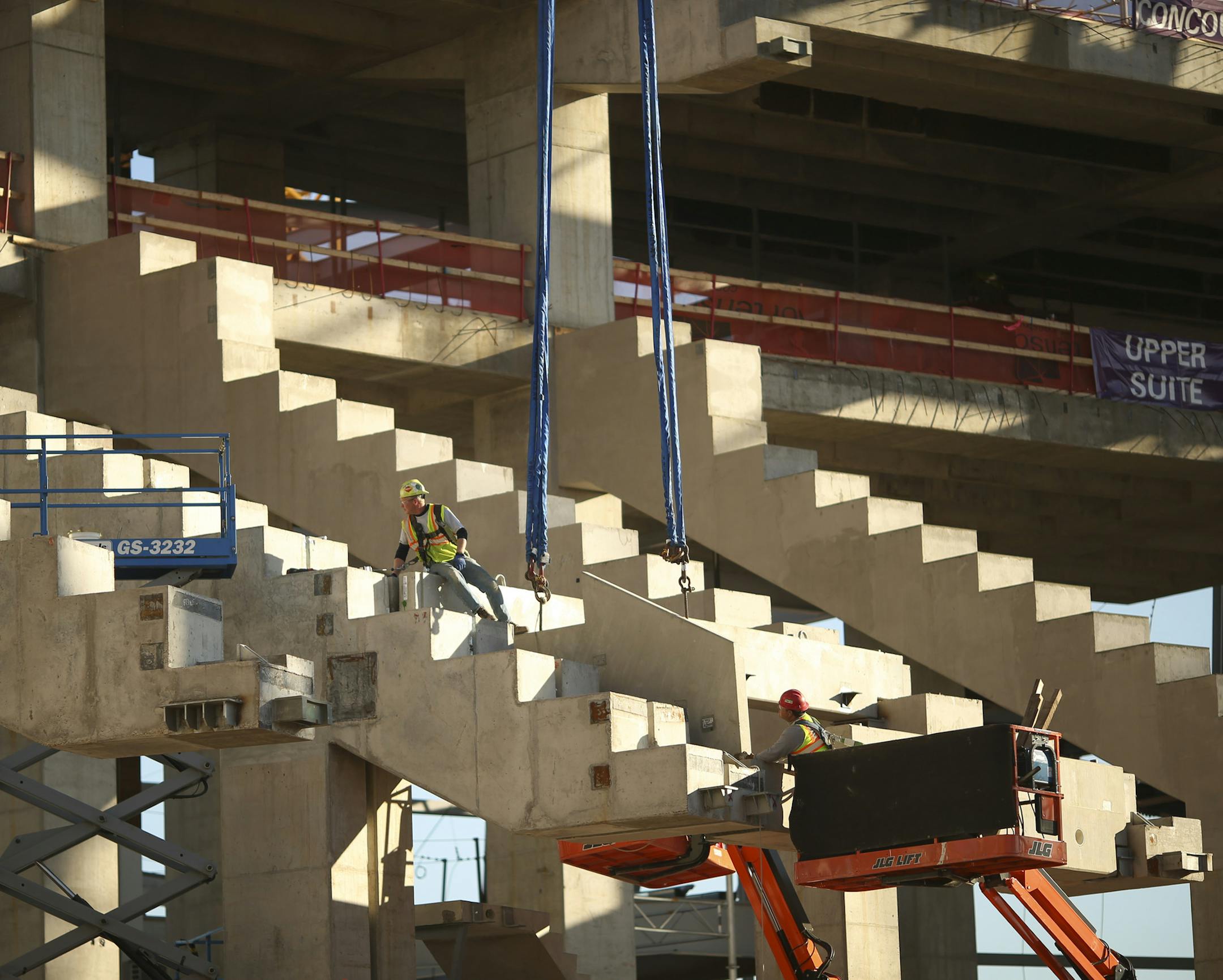 Construction workers eased upper level seat supports into place at the new Vikings stadium Monday afternoon. ] JEFF WHEELER &#x201a;&#xc4;&#xa2; jeff.wheeler@startribune.com Officials from the Vikings and M.A. Mortenson Co. led a media tour of the new Vikings stadium Monday afternoon, October 20, 2014.