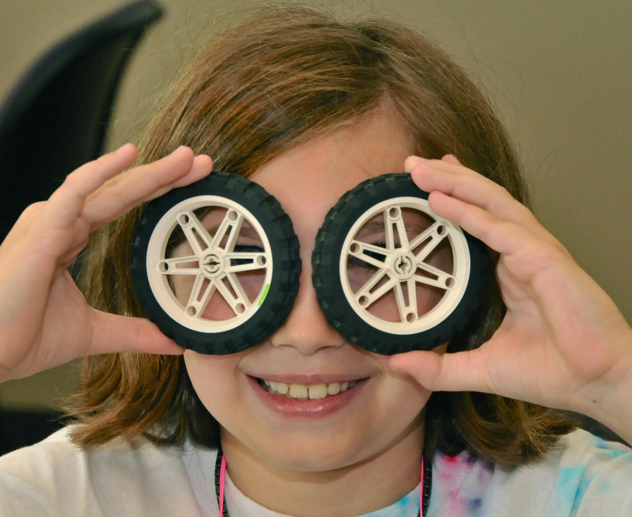 A Girl Scout participates in robotics activities. The robotics program introduces girls to engineering and teaches science and math skills.
