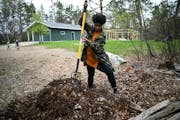 Jovan C. Speller uses a pitchfork to turn a compost pile Thursday, May 19, 2022 in Osage, Minn.. Speller moved her family and her artistic practice to