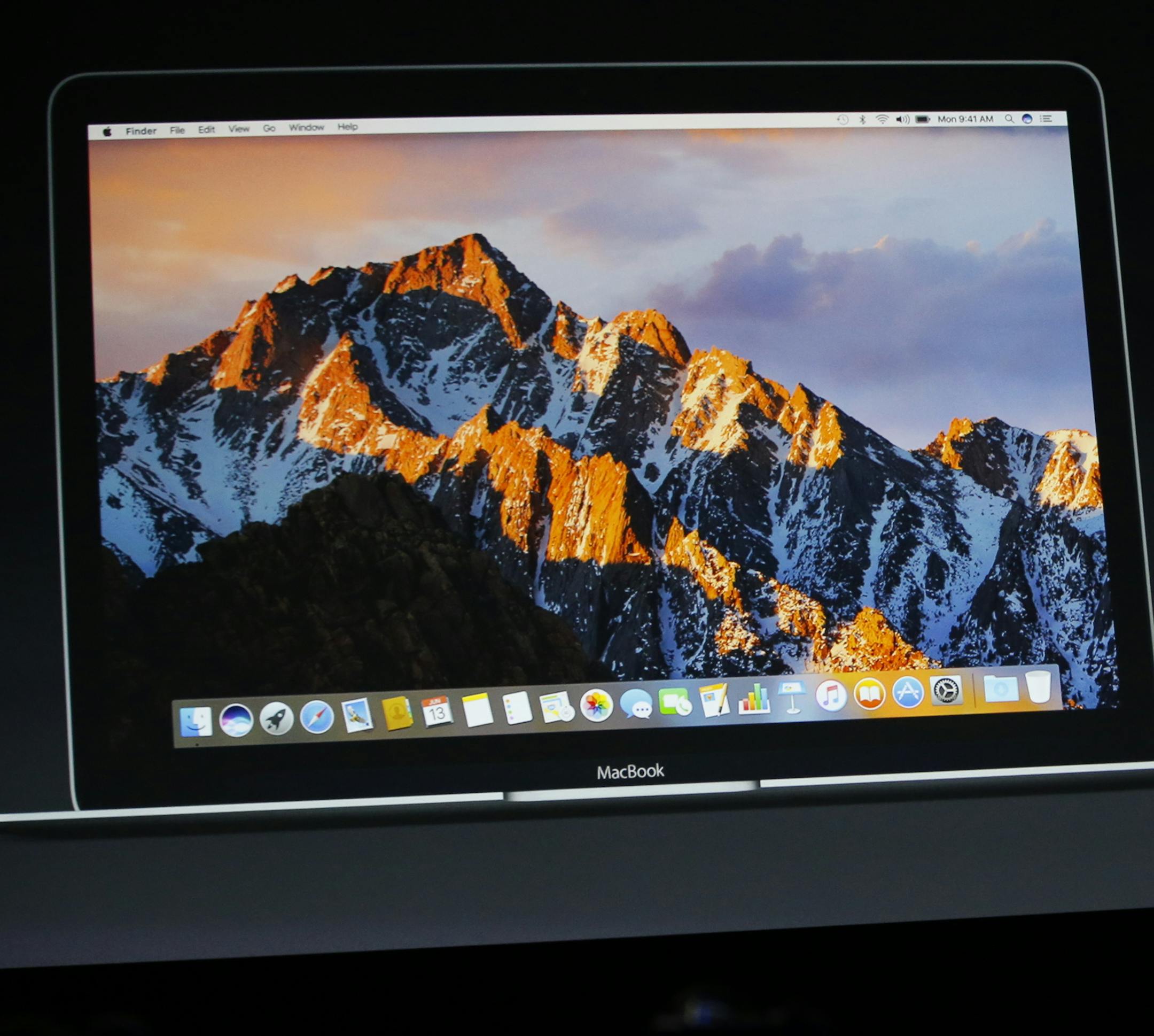 FILE - In this Monday, June 13, 2016, file photo, Craig Federighi, Apple senior vice president of software engineering, speaks about Mac OS Sierra at the Apple Worldwide Developers Conference in the Bill Graham Civic Auditorium in San Francisco. The Sierra update to Mac computers brings iPhone services to desktops and laptops and further breaks down walls between devices. It also borrows an iPad feature for watching video while you work and offers ways to automatically free up storage space. (AP