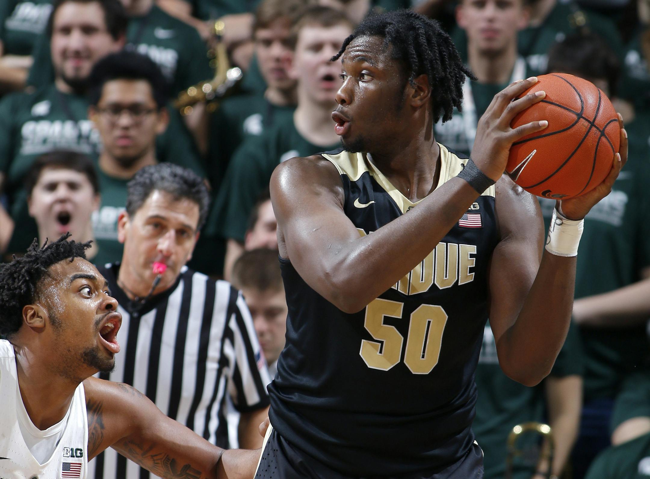 Purdue's Caleb Swanigan (50) maneuvers against Michigan State's Nick Ward during the second half of an NCAA college basketball game, Tuesday, Jan. 24, 2017, in East Lansing, Mich. Purdue won 84-73. (AP Photo/Al Goldis)