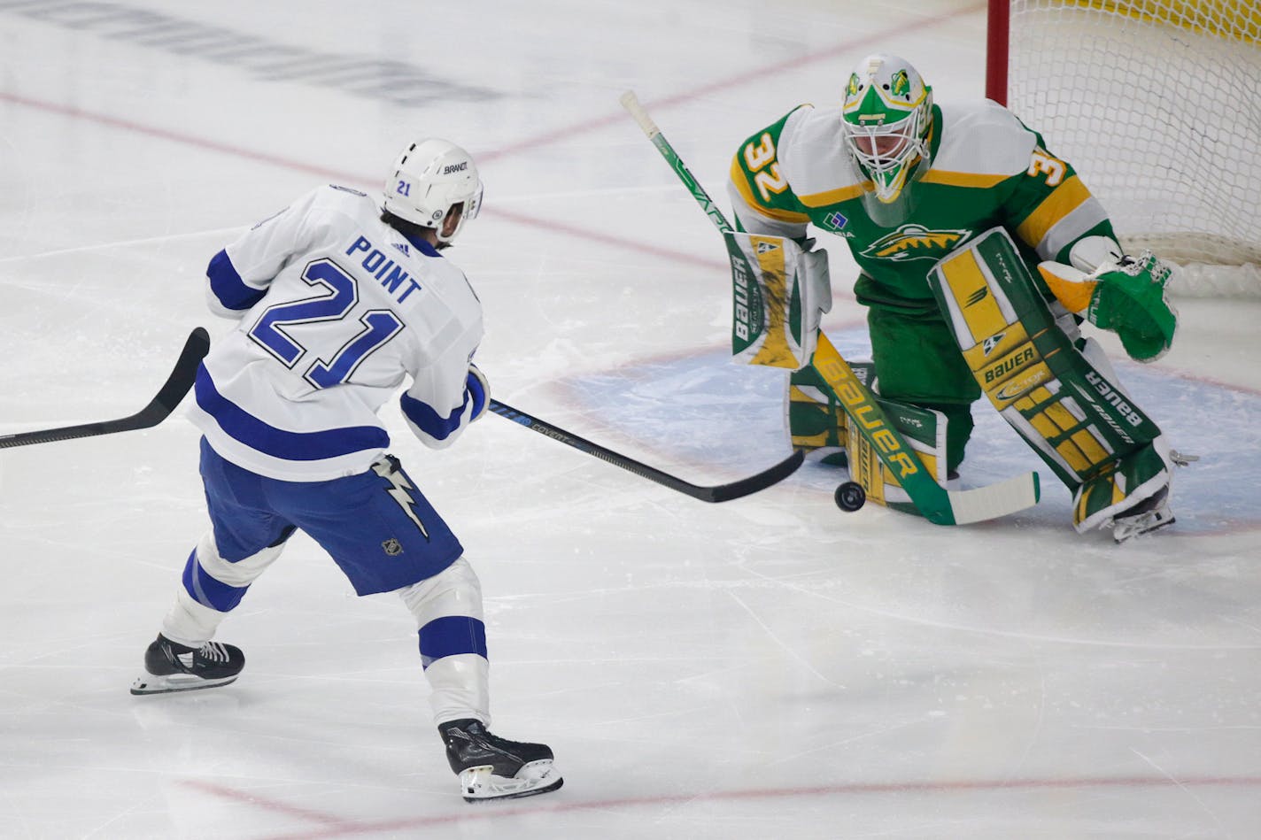 Minnesota Wild goaltender Filip Gustavsson (32) stops a shot by Tampa Bay Lightning center Brayden Point (21) in the first period during an NHL hockey game, Wednesday, Jan. 4, 2023, in St. Paul, Minn. (AP Photo/Andy Clayton-King)