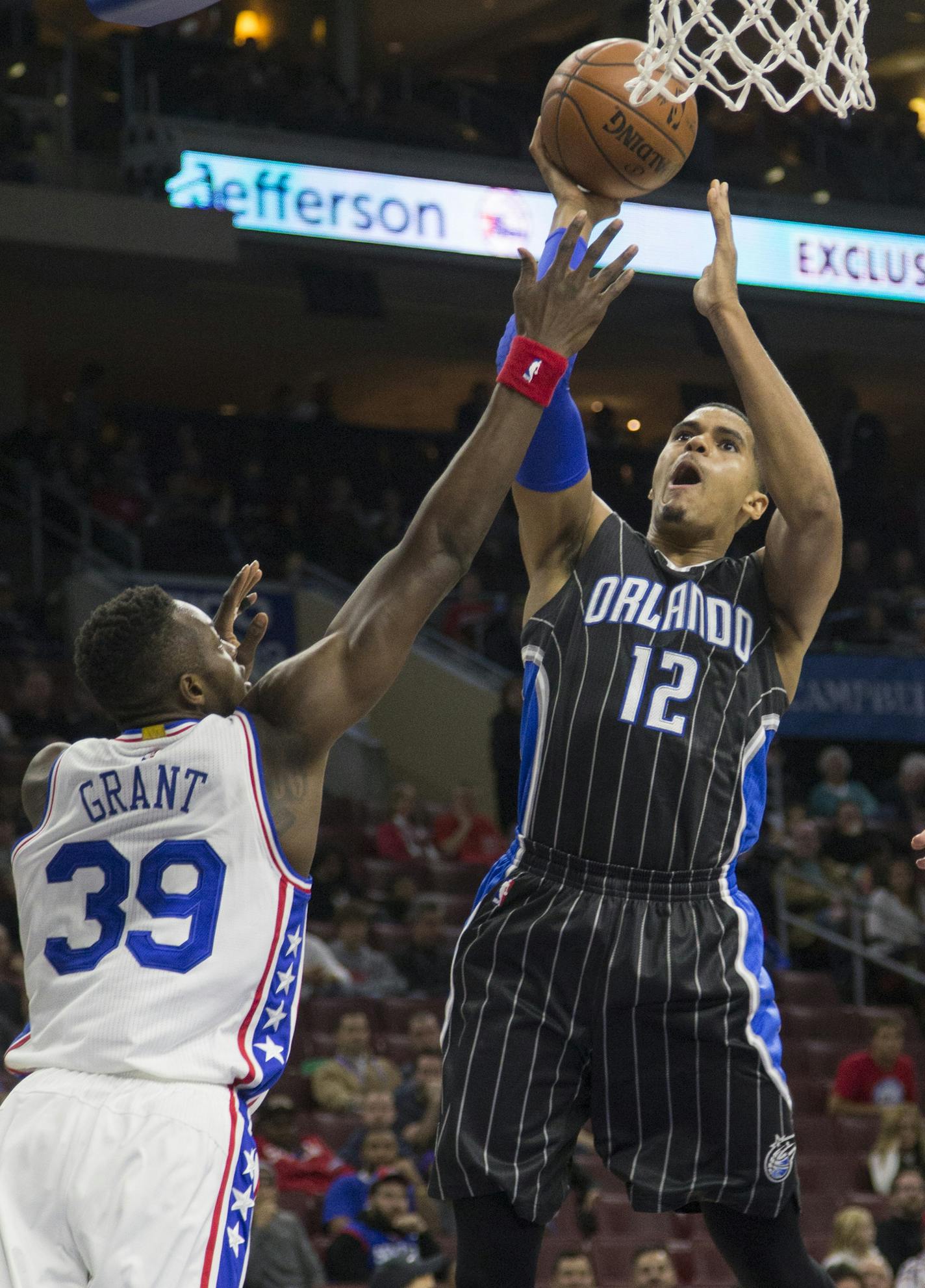 Orlando Magic forward Tobias Harris (12) takes a shot past Philadelphia 76ers' Jerami Grant (39) in the first half of an NBA basketball game, Saturday, Nov. 7, 2015, in Philadelphia. (AP Photo/Laurence Kesterson)