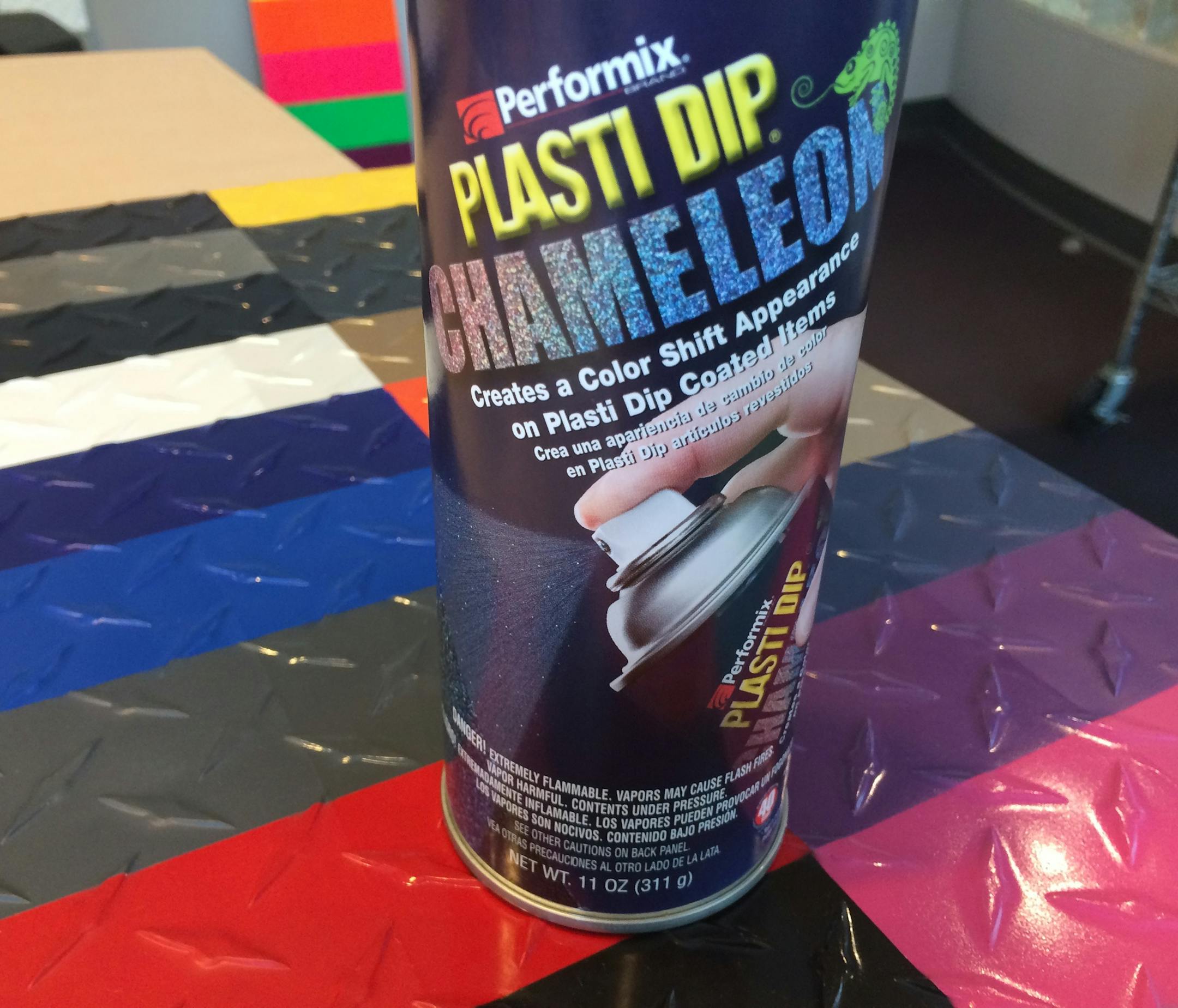 A can of Plasti Dip "Chameleon" spray on top of other color offerings of the decorative-and-protective coating.