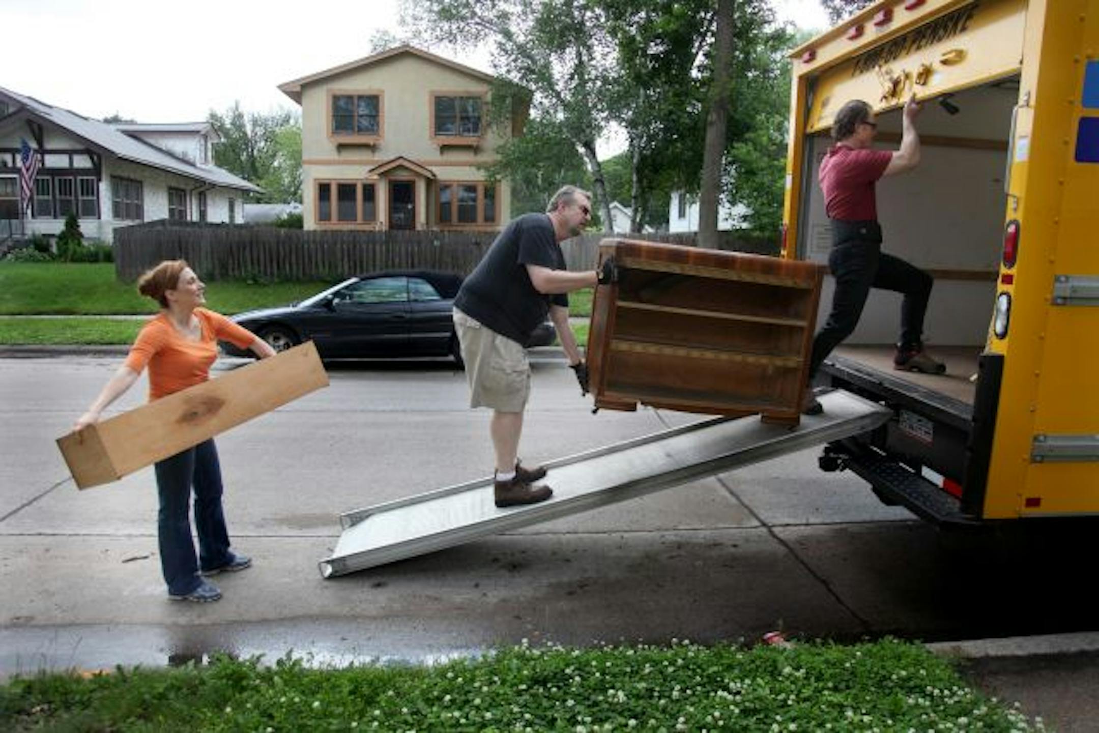 Holly Schroeder, left, received help from fellow actor Clark Cruikshank, center, and Jochen Scherr, cq, as they showed up to help her pack up her home of almost eight years. Schroeder will be moving to Chicago, near her hometown.