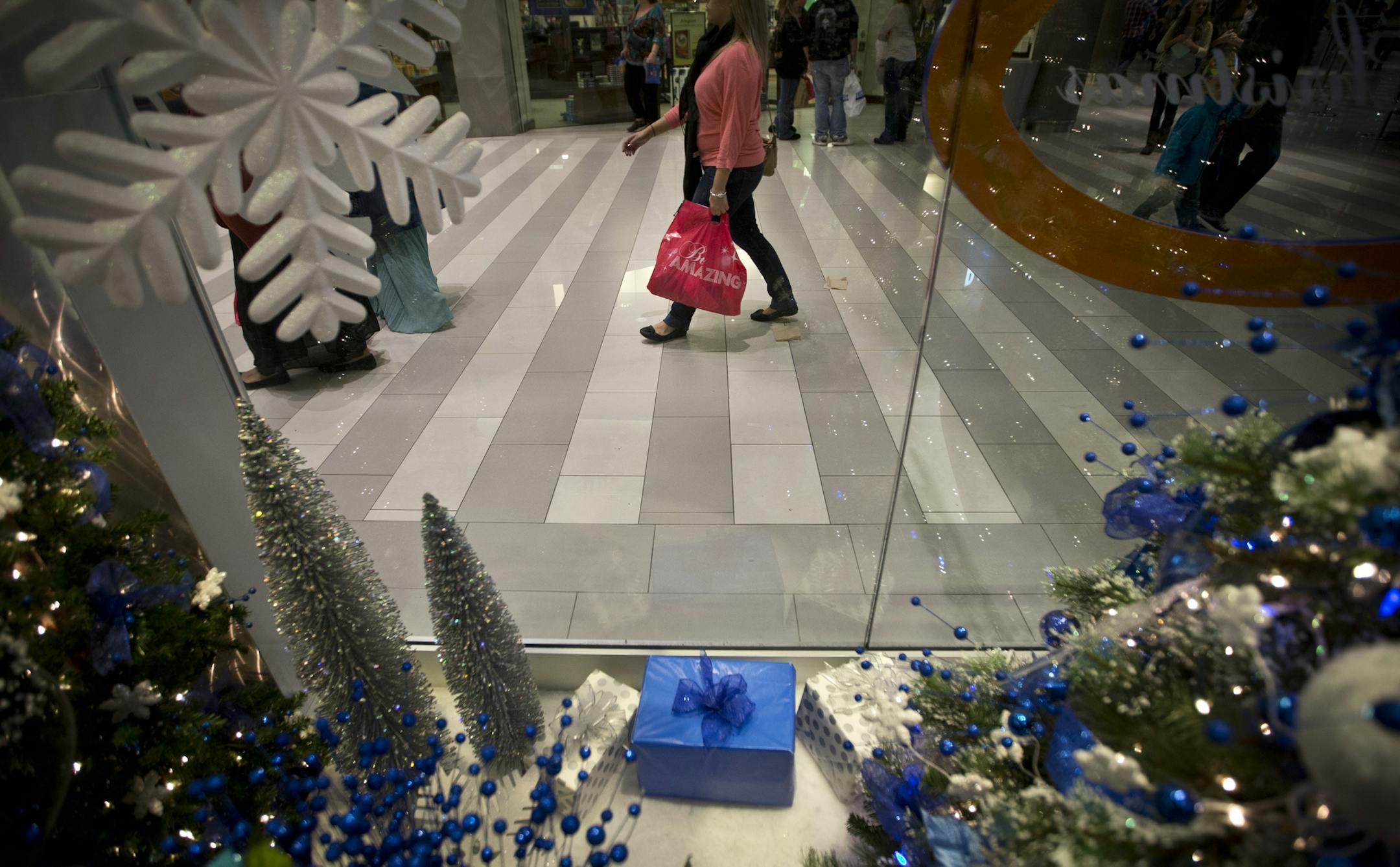 Shoppers walked past a Christmas themed store at the Mall of America in Bloomington, Minn., on October 17, 2013. The shaky consumer confidence is pummeling sales forecasts for the holiday season, a crucial period that can account for up to 40 percent of a retailer's annual revenue. ] RENEE JONES SCHNEIDER • reneejones@startribune.com
