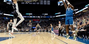 Timberwolves guard Anthony Edwards made a three-pointer while defended by the Spurs' Victor Wembanyama in the third quarter Tuesday night.