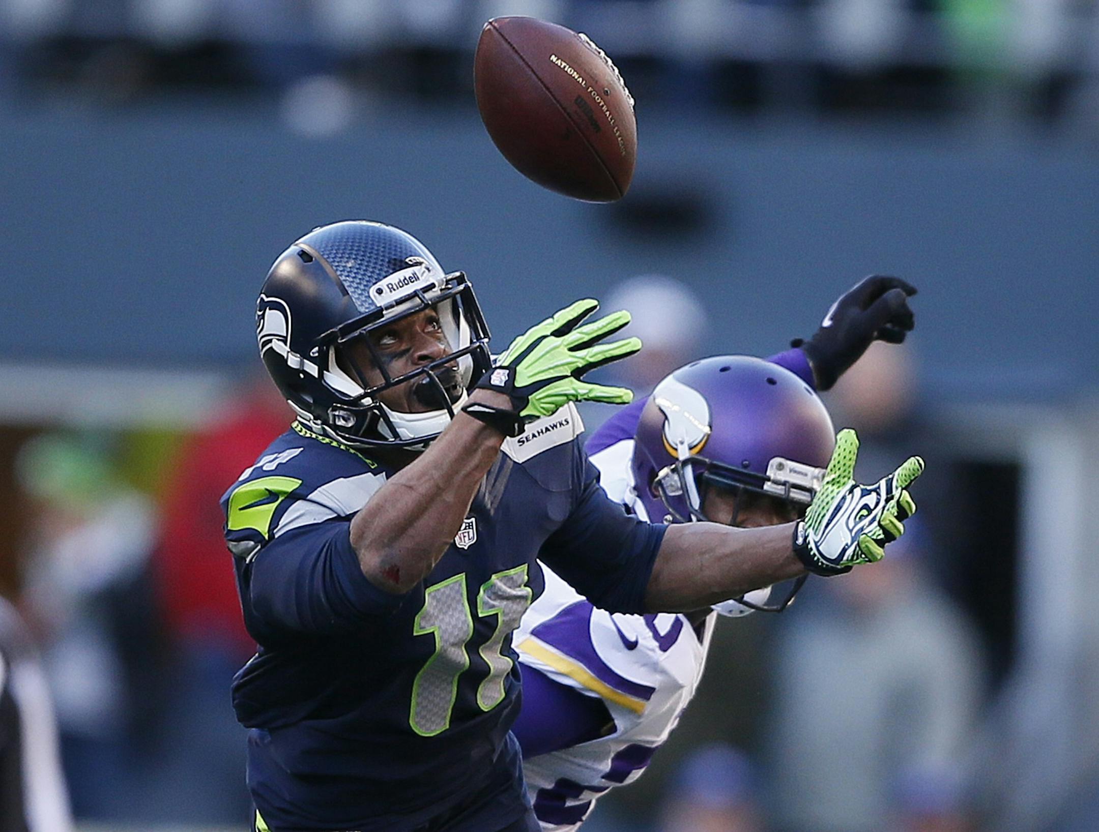 Seattle Seahawks wide receiver Percy Harvin (11) pulled down his first catch of the season over Minnesota Vikings cornerback Chris Cook (20) in the second quarter during NFL action between the Minnesota Vikings and Seattle Seahawks at CentruyLink Field Sunday November 17, 2013 in Seattle , WA.