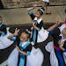 Members of a dance troop from the Community School of Excellence in St. Paul practiced before performing updated Hmong folkloric dances to celebrate L