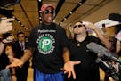 Former NBA basketball player Dennis Rodman, and Chris Volo, right, arrive at Singapore's Changi Airport on Tuesday, June 12, 2018.