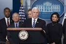 Vice President Mike Pence, accompanied by Dr. Anthony Fauci, director at the National Institute of Allergy and Infectious Diseases, left, and other he