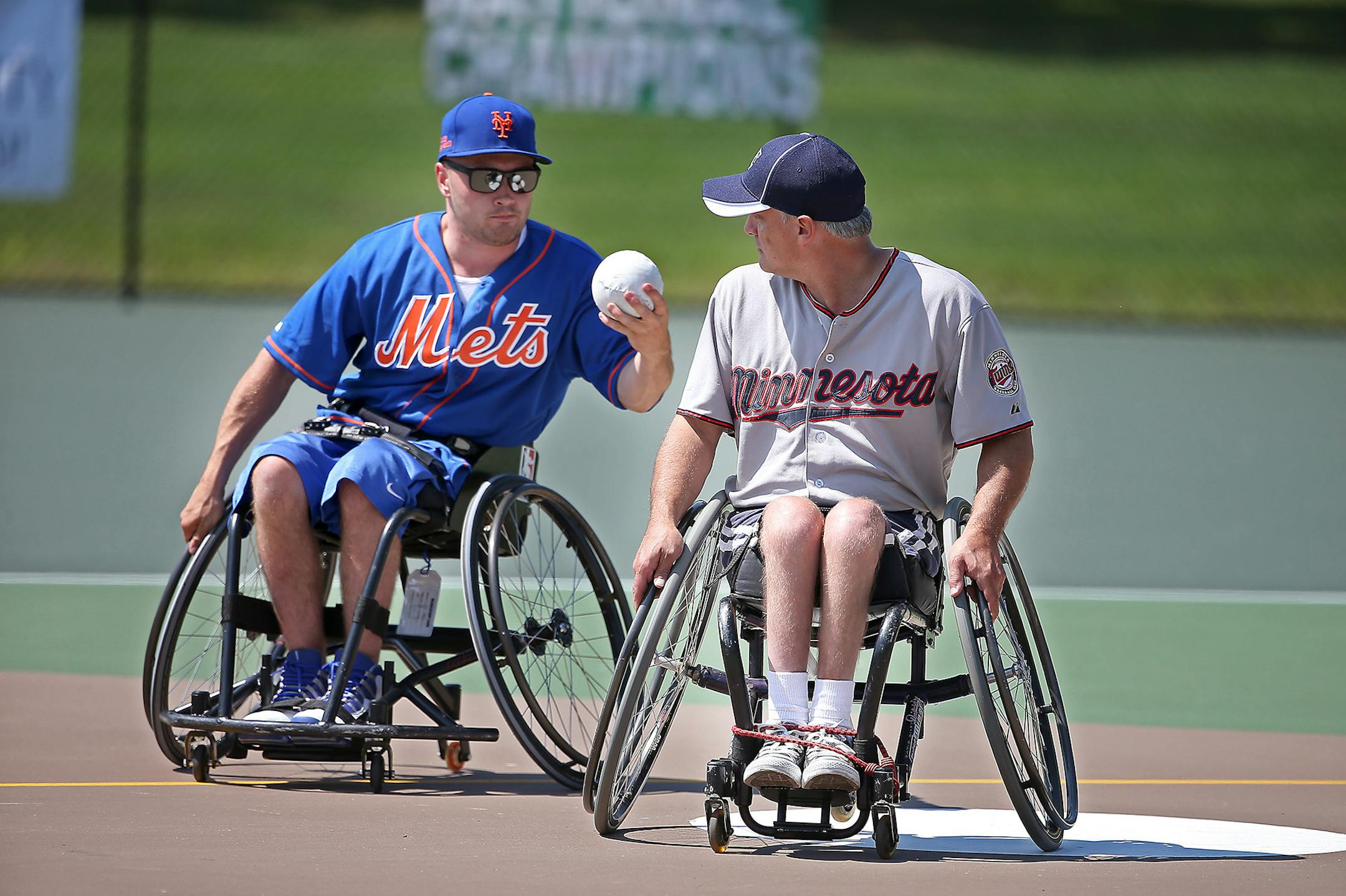 Minnesota Rolling Twins' Kurt Greniger made is safely to first before New York Mets' Saverio Marzocca during the first round of play in the Wheelchair Softball World Series, Thursday, August 14, 2014. ] (ELIZABETH FLORES/STAR TRIBUNE) ELIZABETH FLORES • eflores@startribune.com