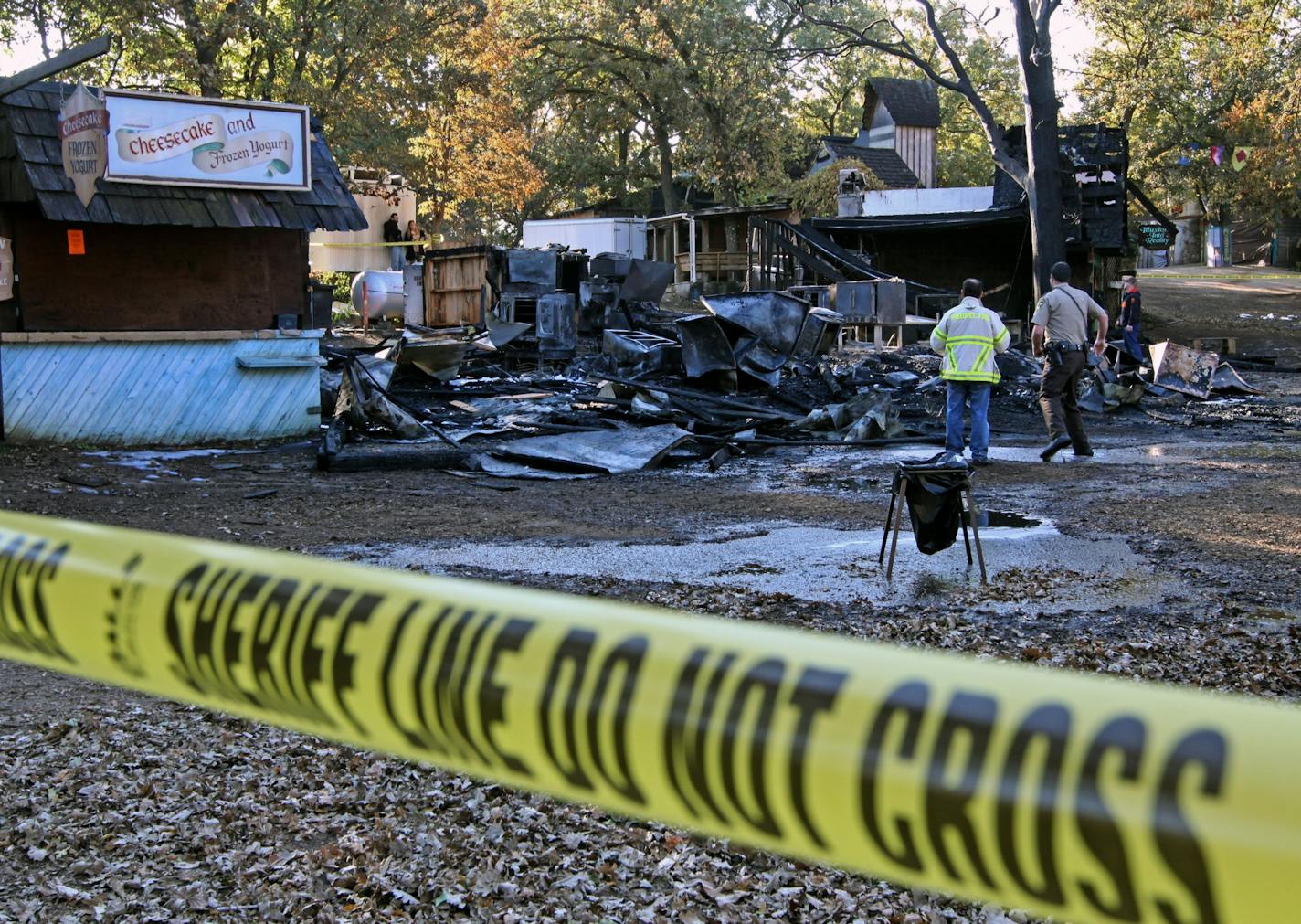 Investigators looked through the rubble after a fire destroyed the Rogues Chicken, Scotch egg, and pizza booths at the Minnesota Renaissance Festival on 9/30/11. There were no injuries reported in the fire and the festival was open for business as usual. Five booths in total were destroyed in the fire.