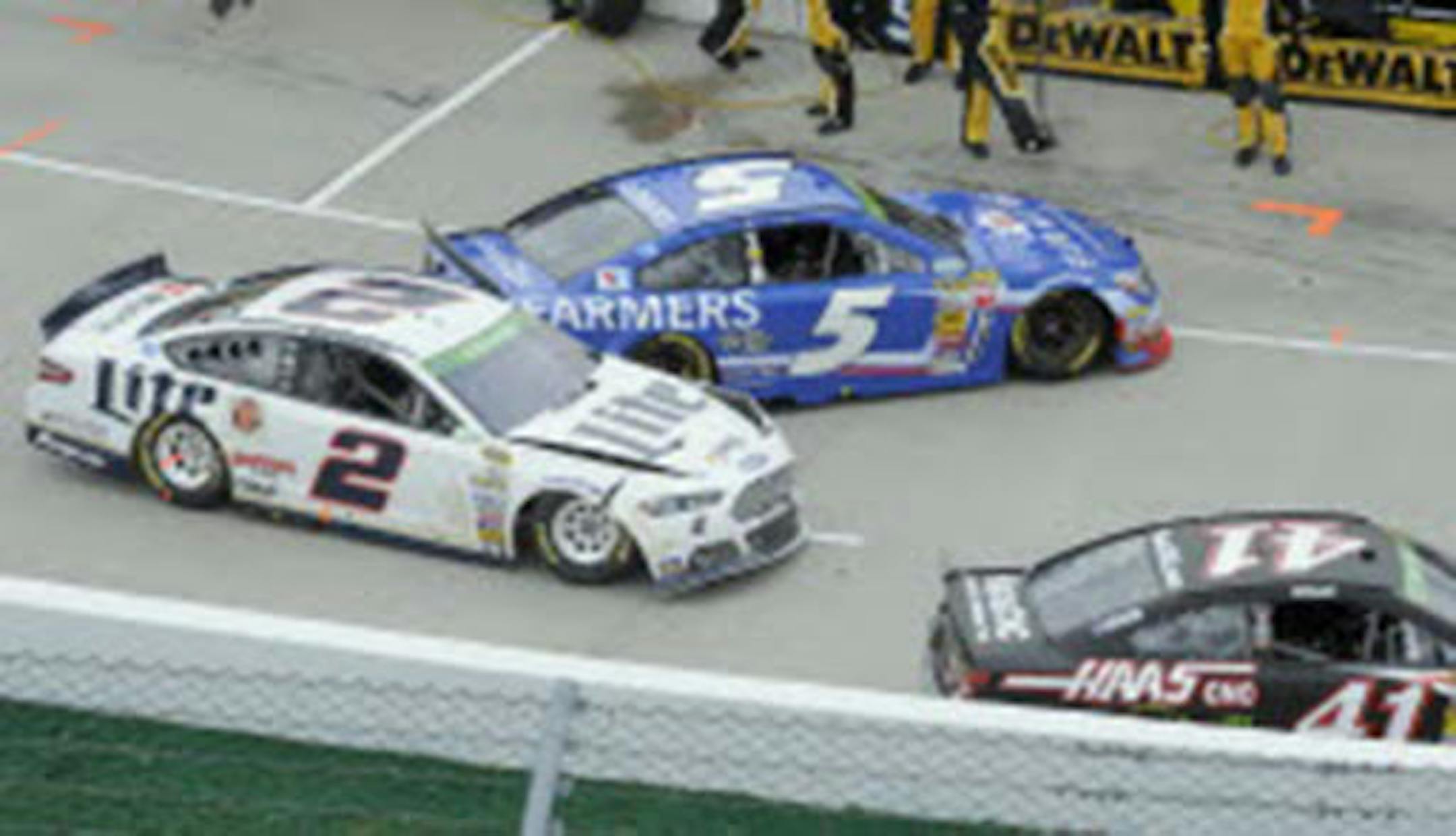 Brad Keselowski's (2) car was damaged in a pit road accident with Kasey Kahan (5) and Kurt Busch (41) during a NASCAR Sprint Cup Series auto race at Martinsville Speedway in Martinsville, Va., on Sunday.