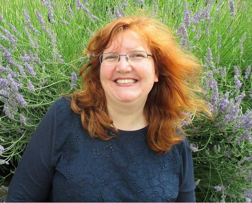 photo of woman in front of lavender flowers