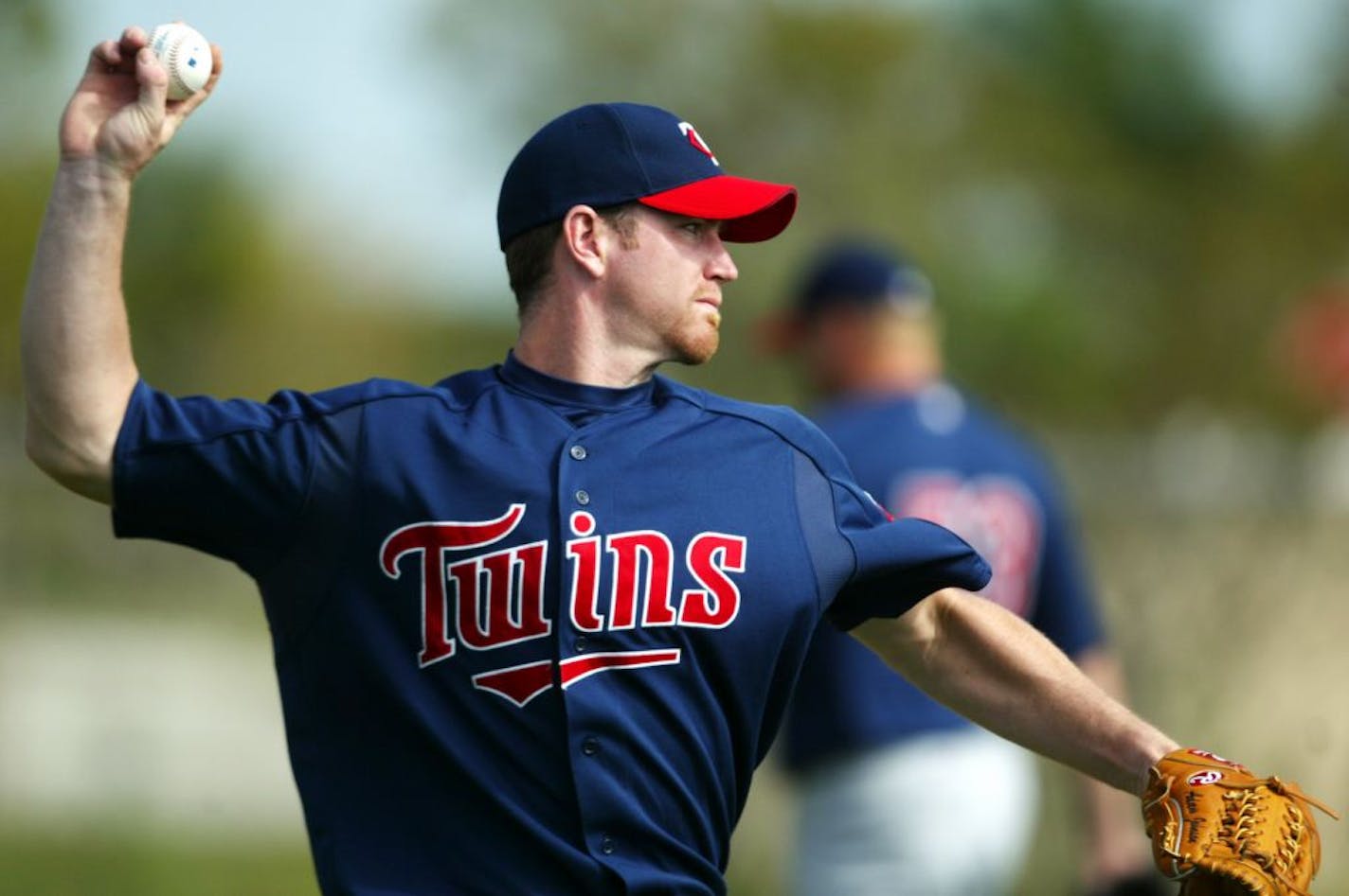 Ft. Myers, FL;3/3/04;left to right:At the Twins spring training facility, Pitcher Adam Johnson goes through some pitching drills.