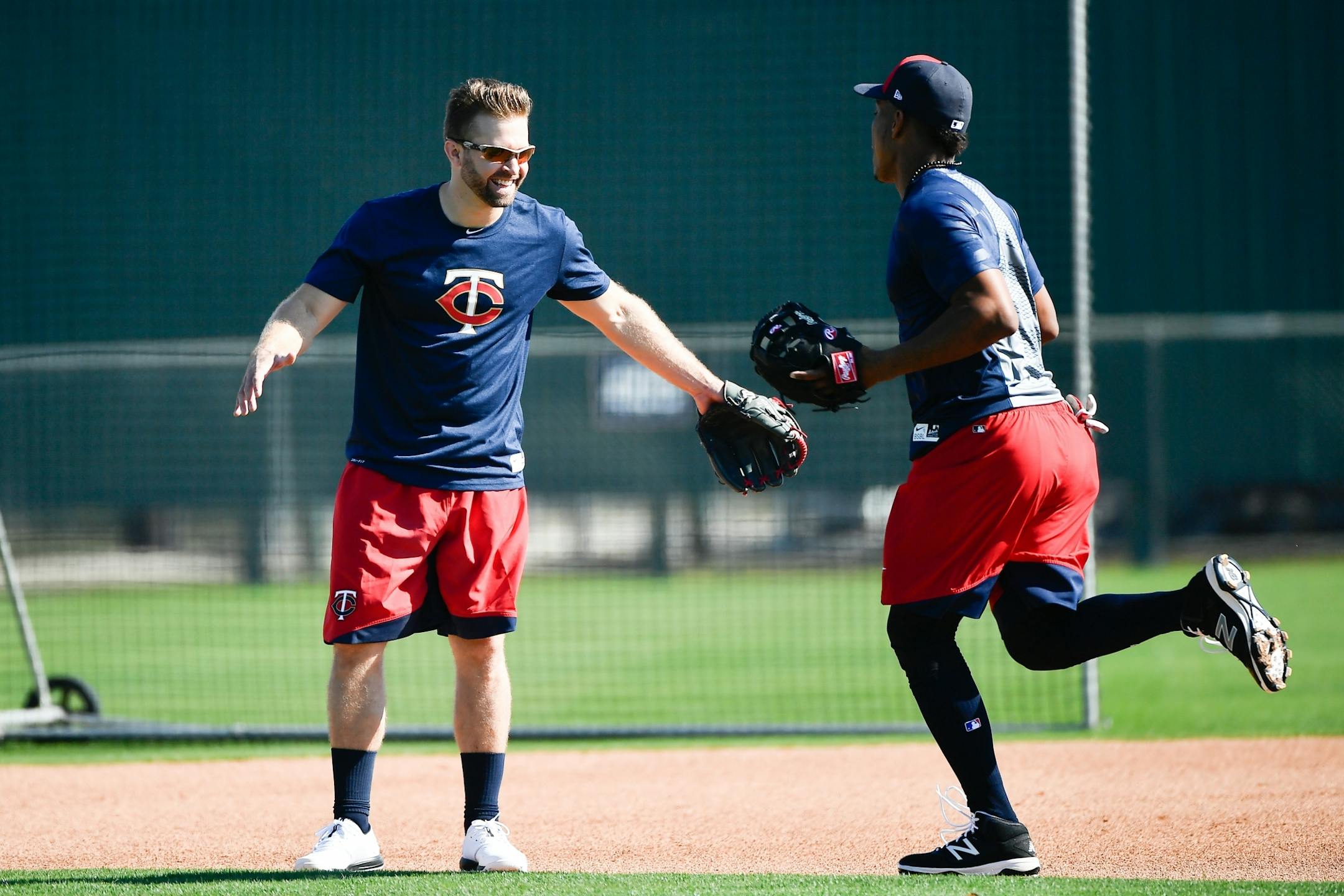 Minnesota Twins second baseman Brian Dozier (2) greeted infielder Jorge Polanco Friday on one of the practice fields at CenturyLink Sports Complex.