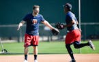 Minnesota Twins second baseman Brian Dozier (2) greeted infielder Jorge Polanco Friday on one of the practice fields at CenturyLink Sports Complex.