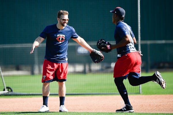 Minnesota Twins second baseman Brian Dozier (2) greeted infielder Jorge Polanco Friday on one of the practice fields at CenturyLink Sports Complex.