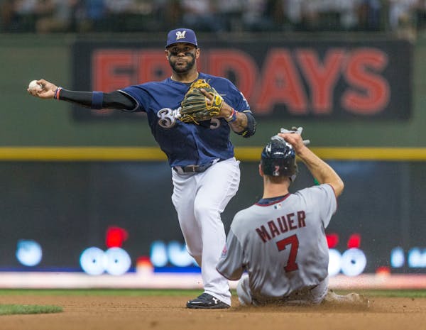 Milwaukee Brewers' Jonathan Villar turns the double play after getting Minnesota Twins' Joe Mauer at second base during a Border Battle game in 2017.