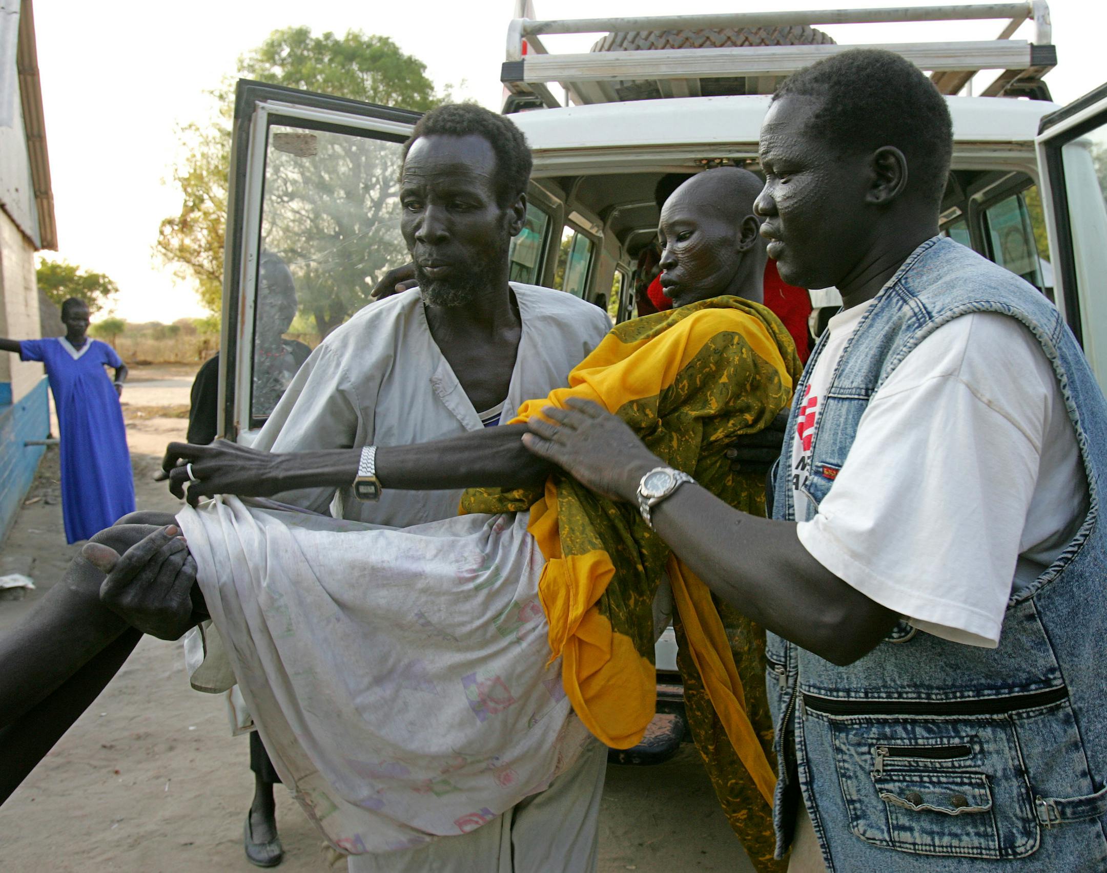**FILE** Nyatudy Riak Marial, who is suspected to suffer from the parasitic disease Kala azar, is carried by members of Medicins Sans Frontieres as she arrives at the Medicins Sans Frontieres hospital in this Saturday, Dec. 17, 2005 file picture in Leer in Southern Sudan.The sickness starts with the bite of a tiny sand fly and mutates quickly from there _ chills, then fever, then an onslaught of black lesions that will most likely prove fatal within six months without treatment.Known as kala aza