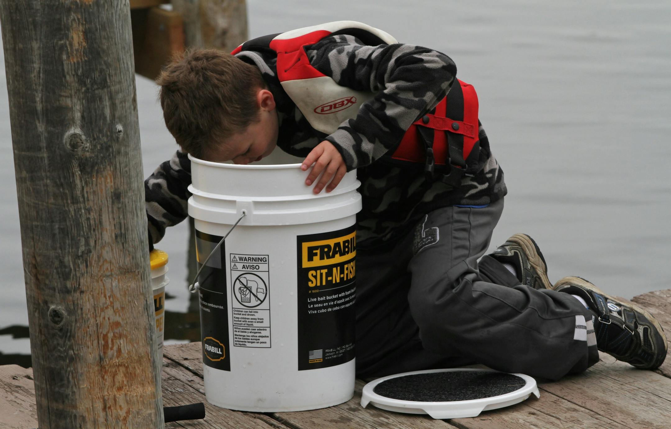 Noah Goodrich, age-9 from Minnetonka, dug deep in the bucket to get just the right minnow as he fished off the docks at Lord Fletchers in the Minnesota Bound's Crappie Contest on Lake Minnetonka. Under sponsorship by Ron Schara's Minnesota Bound television show, the contest pre-registered over 1000 anglers for the event based out of Lord Fletcher's on Lake Minnetonka, 5/5/12.