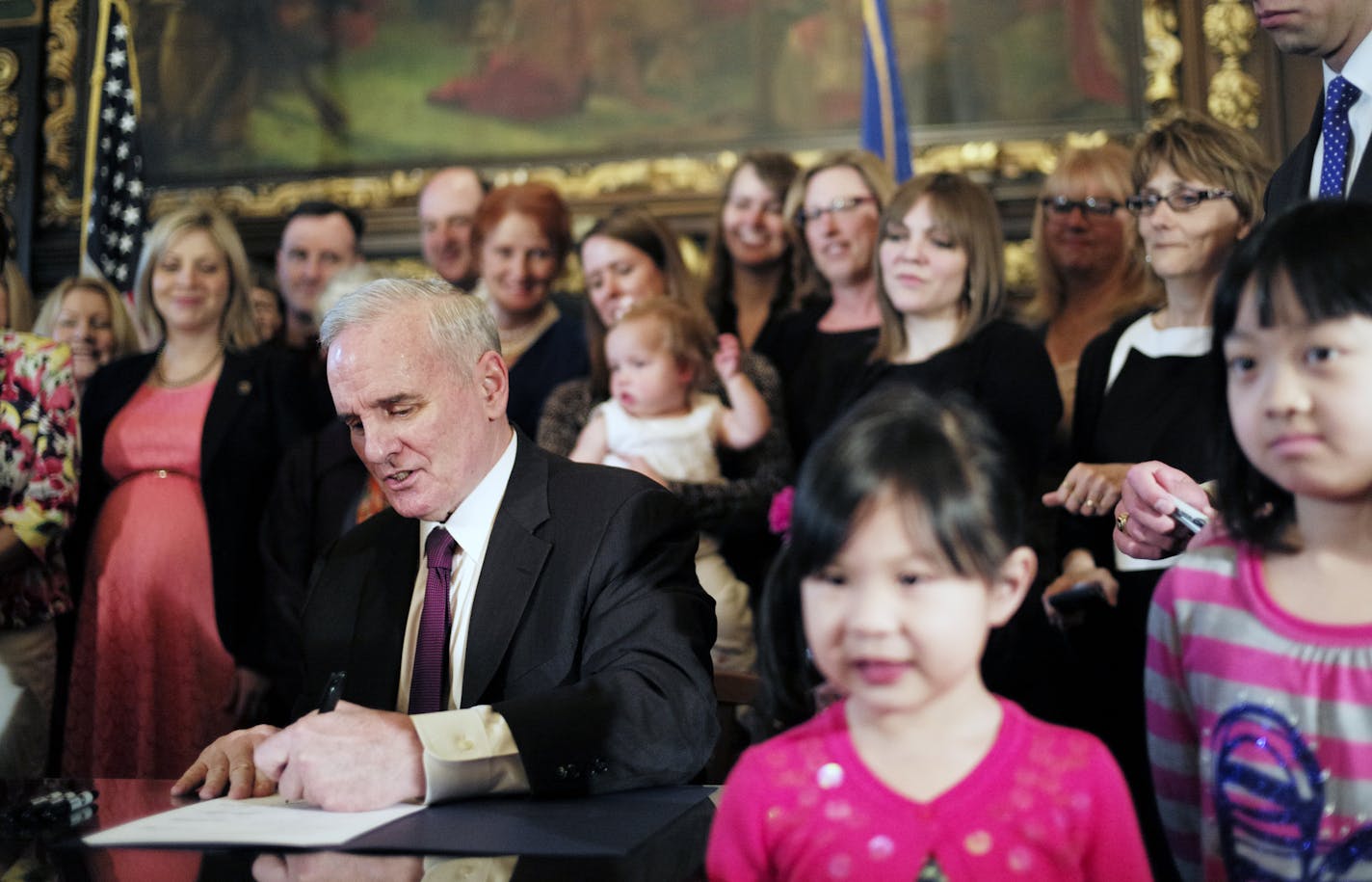 In the governor&#x2019;s reception room at the State Capitol in St. Paul on Sunday, Gov. Dayton signed the Women&#x2019;s Economic Security Act to improve conditions for working women.