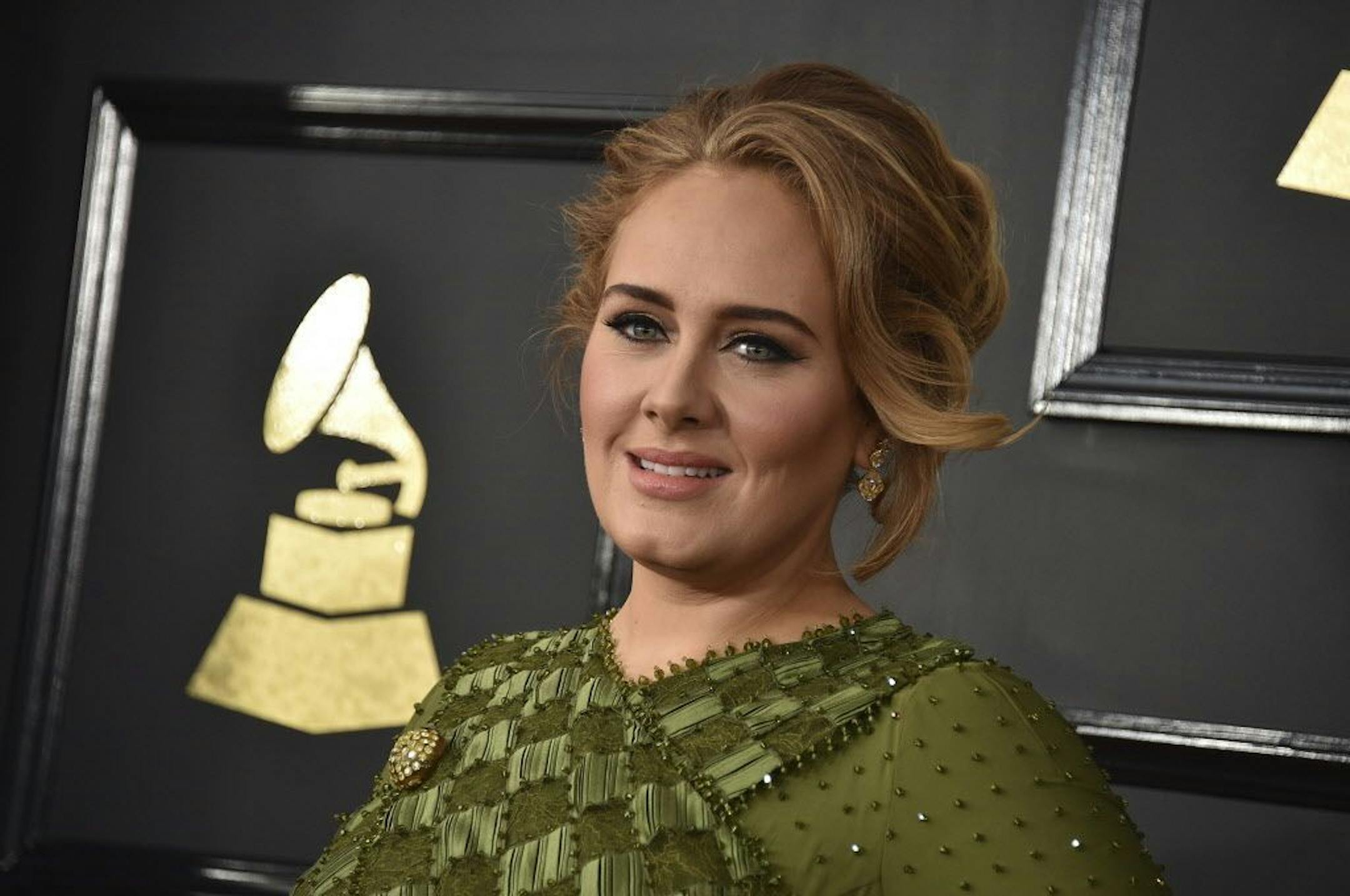 FILE - In this Feb. 12, 2017, file photo, Adele arrives at the 59th annual Grammy Awards at the Staples Center in Los Angeles. Adele confirmed her marriage to partner Simon Konecki in remarks to the audience at her concert in Brisbane, Australia, on Saturday, March 4, 2017.