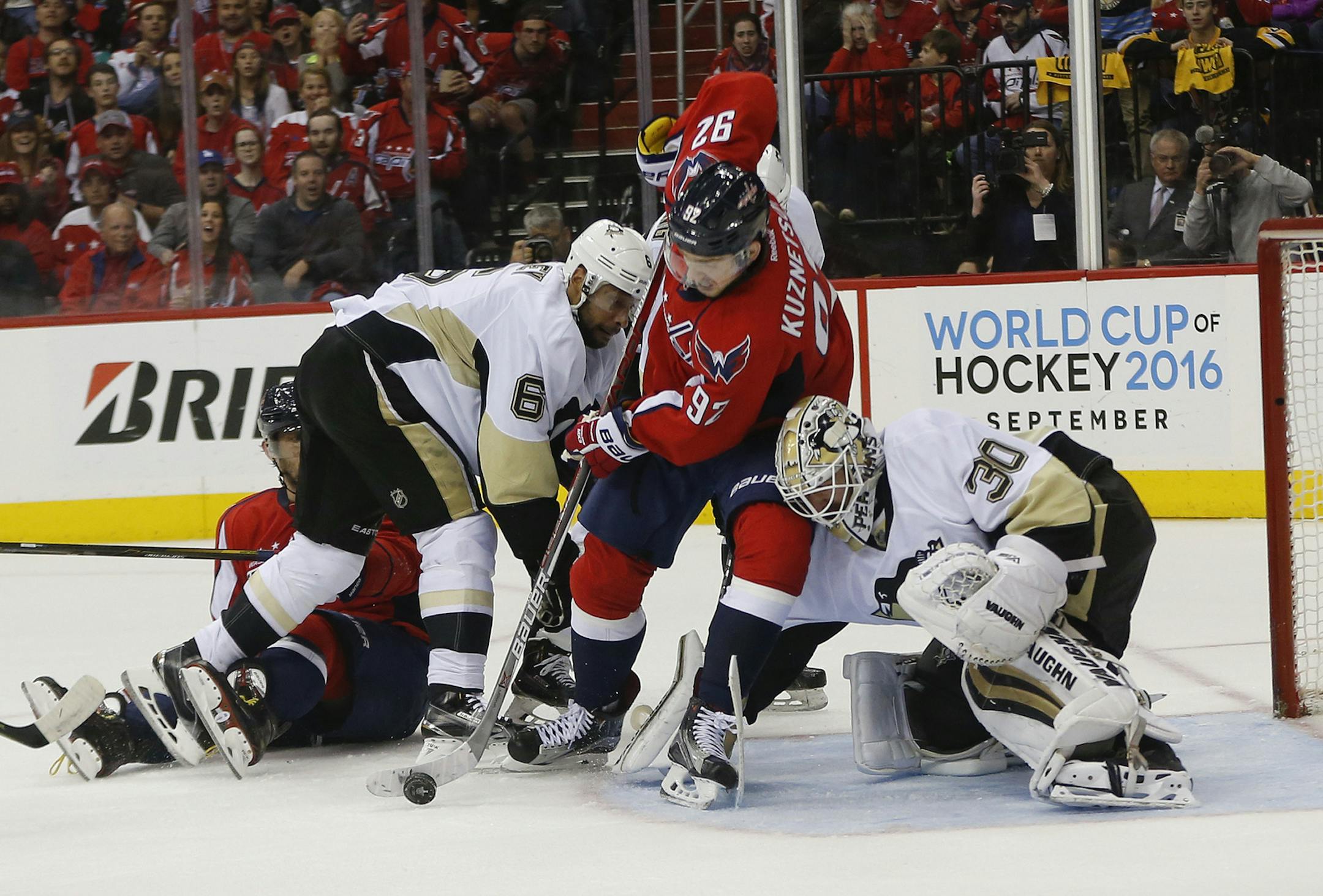Washington Capitals center Evgeny Kuznetsov (92) tries to score against Pittsburgh Penguins goalie Matt Murray (30) and defenseman Trevor Daley (6) during the second period of Game 2 in an NHL hockey Stanley Cup Eastern Conference semifinals Saturday, April 30, 2016 in Washington. Capitals left wing Alex Ovechkin, left, looks on. (AP Photo/Pablo Martinez Monsivais)