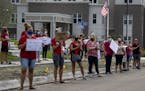 The members of Anoka-Hennepin Education Minnesota held a rally ahead of an August school board meeting at Sandburg Education Center in Anoka.