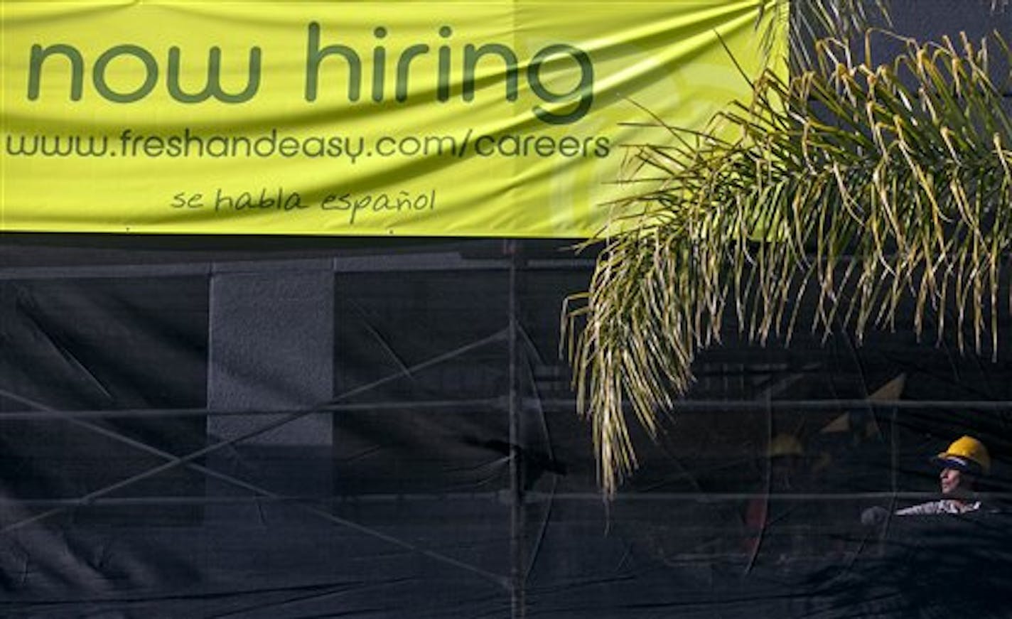 This Friday, Dec. 7, 2012, photo, shows a construction worker at a new site for a future Fresh & Easy supermarket in Los Angeles. The average number of people seeking U.S. unemployment benefits in December fell to the lowest level since March 2008, a sign that the job market is healing. (AP Photo/Damian Dovarganes)