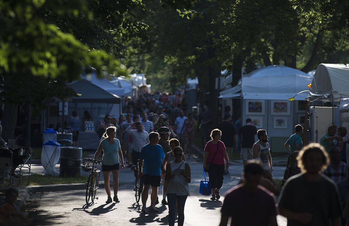 People walked on the "mall" at the Uptown Art Fair in Minneapolis, Minn. on Friday August 7, 2015. ] RACHEL WOOLF &#xb7; rachel.woolf@startribune.com The Uptown Art fair features worldwide artists, live music, and various art activities. The fair will continue through Sunday August 9, 2015.