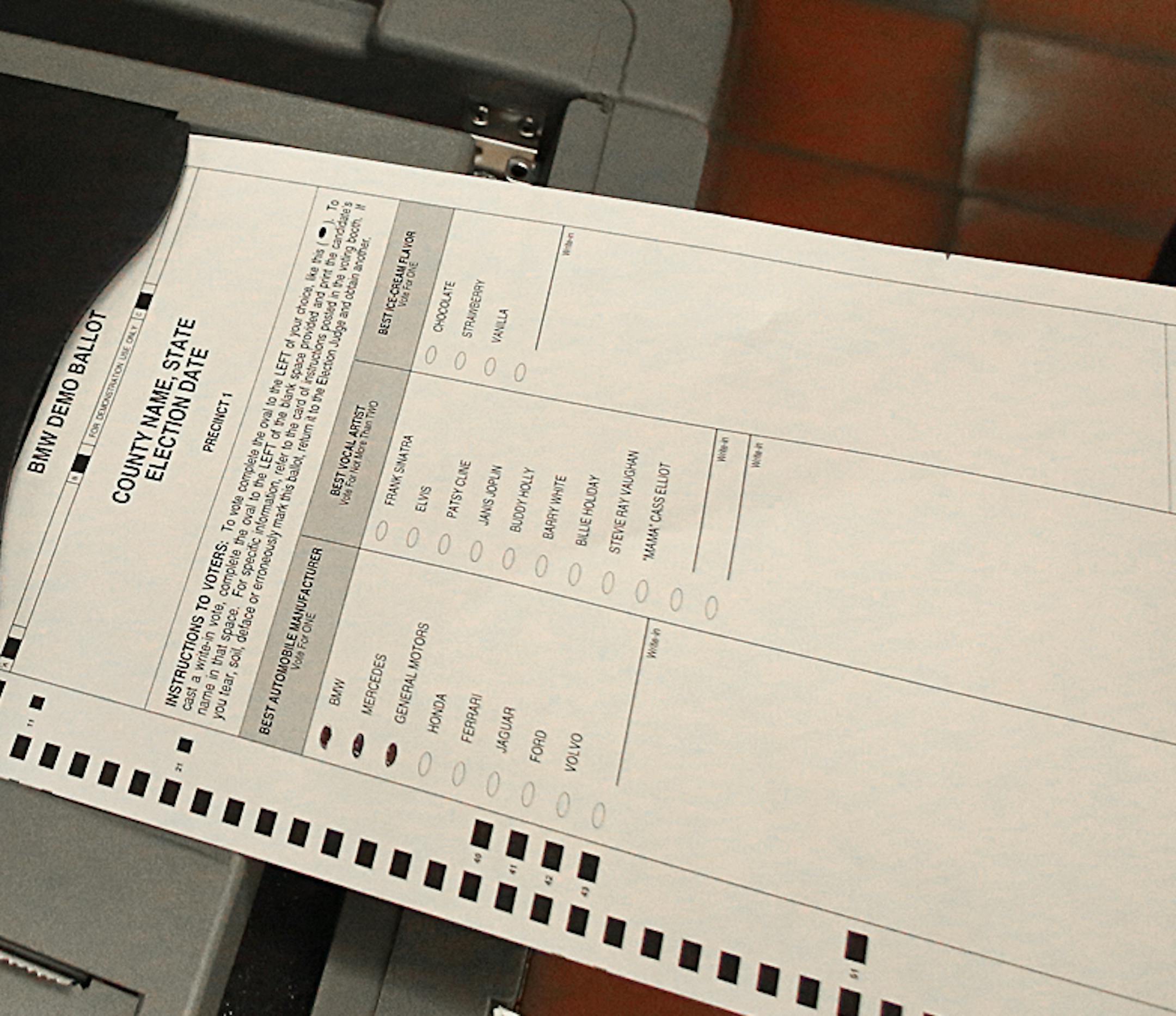 Hennepin County Elections official Luke Belant demonstrated how a ballot will be cast in a new generation of election machines (this one on display at the Hennepin County Government Center), which will be used in metro polling places.