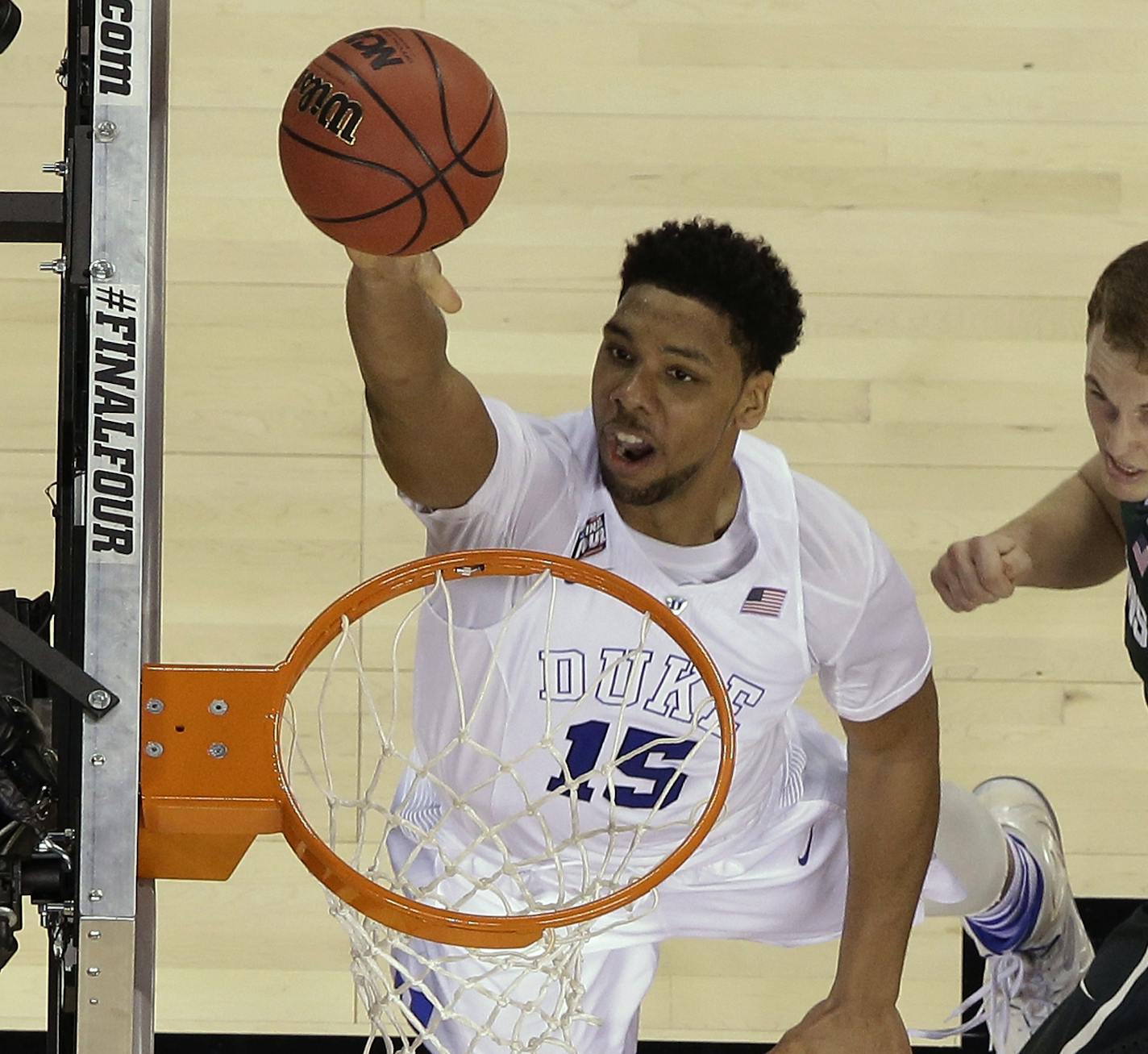 Duke's Jahlil Okafor (15) goes up for a shot against Michigan State's Colby Wollenman and Denzel Valentine (45) during the second half of the NCAA Final Four tournament college basketball semifinal game Saturday, April 4, 2015, in Indianapolis. (AP Photo/David J. Phillip)