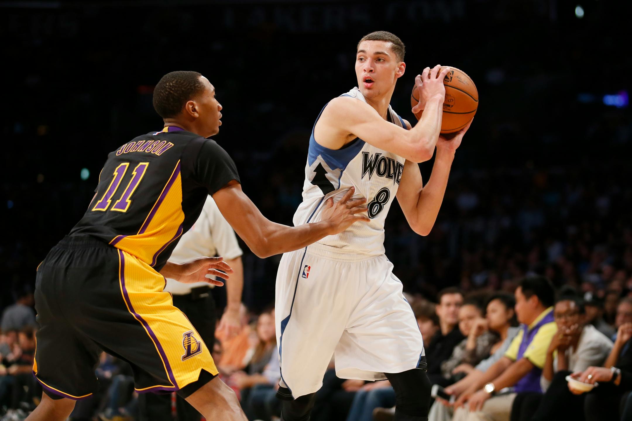 Minnesota Timberwolves' Zach LaVine is defended by Los Angeles Lakers' Wesley Johnson during the first half of an NBA basketball game Friday, Nov. 28, 2014, in Los Angeles. (AP Photo/Danny Moloshok)