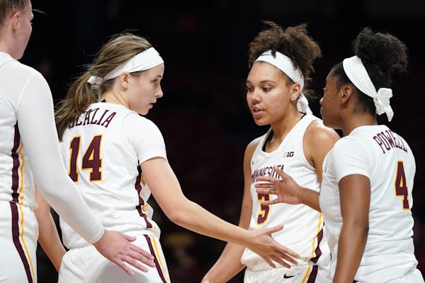 Minnesota Golden Gophers guard Sara Scalia (14) was congratulated by her teammates after she made a last second shot in the second half.