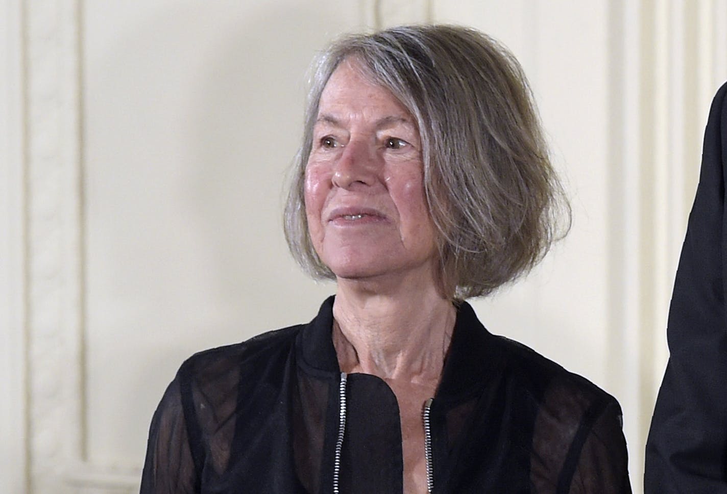 FILE - In this Sept. 22, 2016, file photo poet Louise Gluck stands next to President Barack Obama before being awarded with the 2015 National Humanities Medal during a ceremony in the East Room of the White House in Washington. The 2020 Nobel Prize for literature has been awarded to American poet Louise Gluck "for her unmistakable poetic voice that with austere beauty makes individual existence universal." The prize was announced Thursday Oct. 8, 2020, in Stockholm by Mats Malm, the permanent se