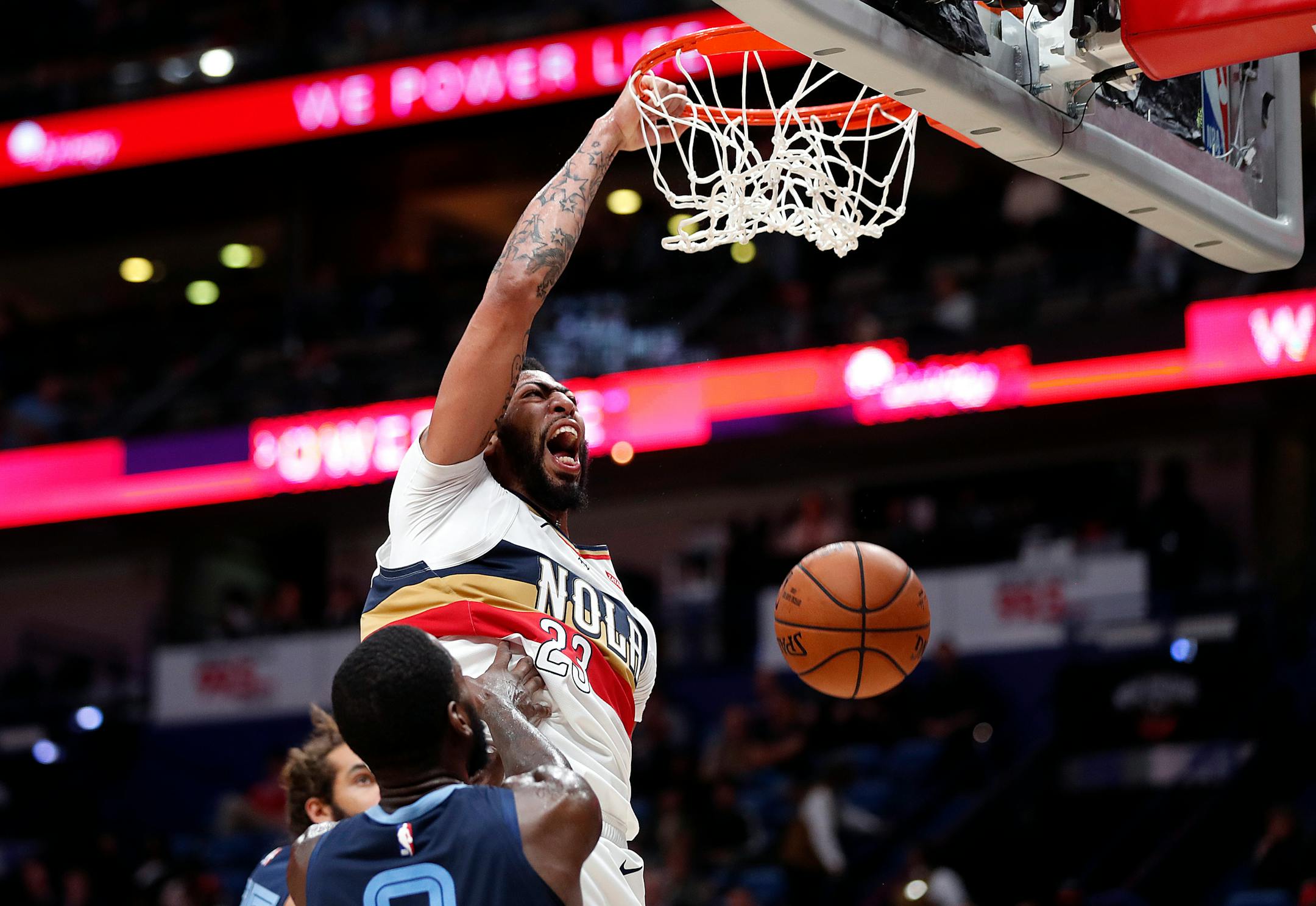New Orleans Pelicans forward Anthony Davis (23) slam-dunks over Memphis Grizzlies forward JaMychal Green (0) in the second half of an NBA basketball game in New Orleans, Monday, Jan. 7, 2019. (AP Photo/Gerald Herbert)