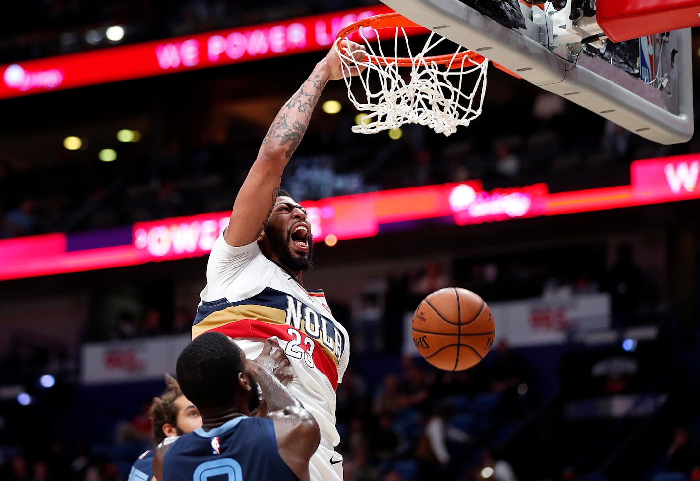 New Orleans Pelicans forward Anthony Davis (23) slam-dunks over Memphis Grizzlies forward JaMychal Green (0) in the second half of an NBA basketball game in New Orleans, Monday, Jan. 7, 2019. (AP Photo/Gerald Herbert)