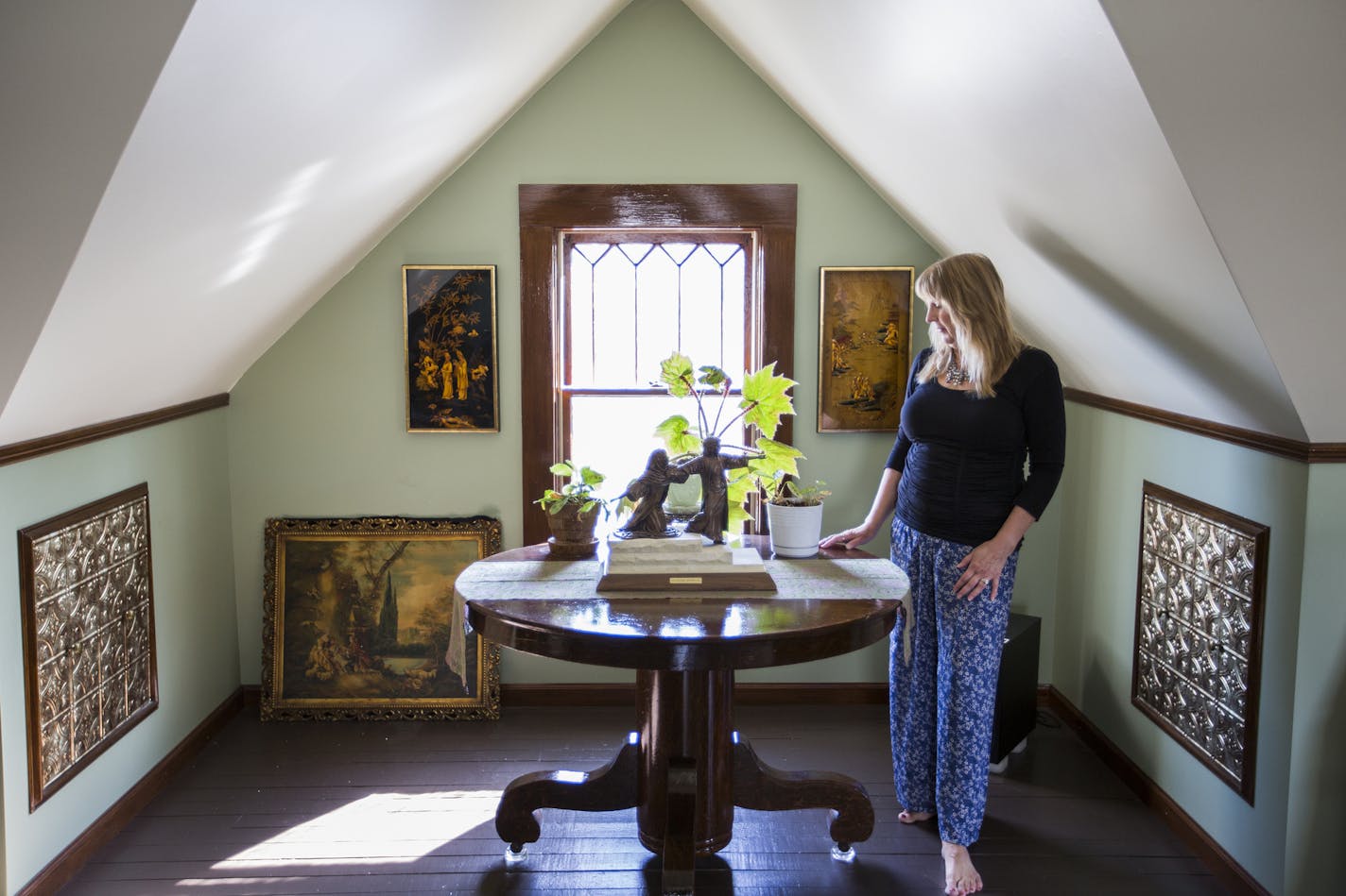 Carol Murto and Robert Nicpon turned the open rafter attic in their 1913 home into a comfortable TV room, artist studio and gallery.