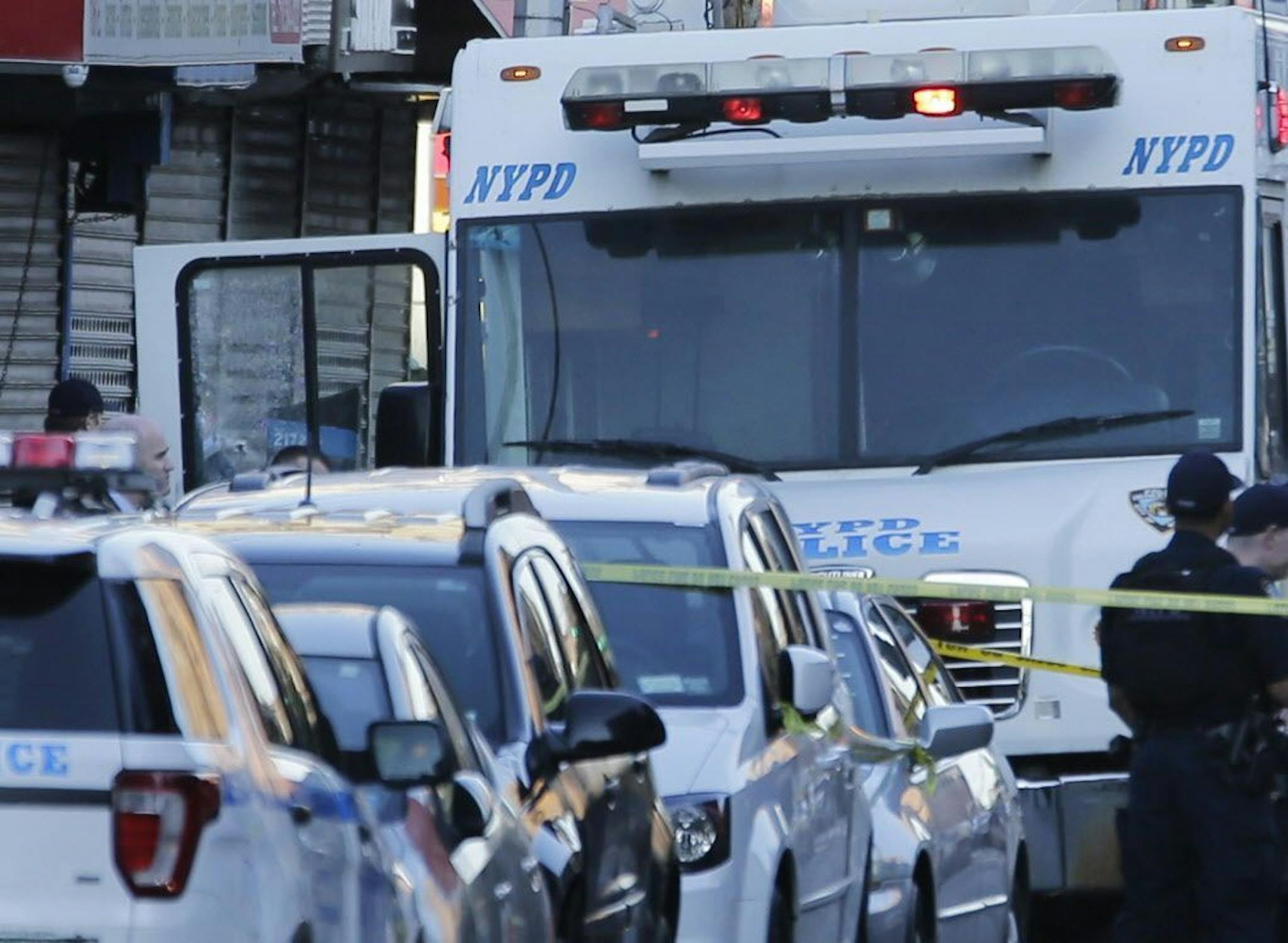 An NYPD vehicle with a cracked window sits on the scene where a police officer was fatally shot in the Bronx section of New York, Wednesday, July 5, 2017. Police said Officer Miosotis Familia died at a hospital early Wednesday.
