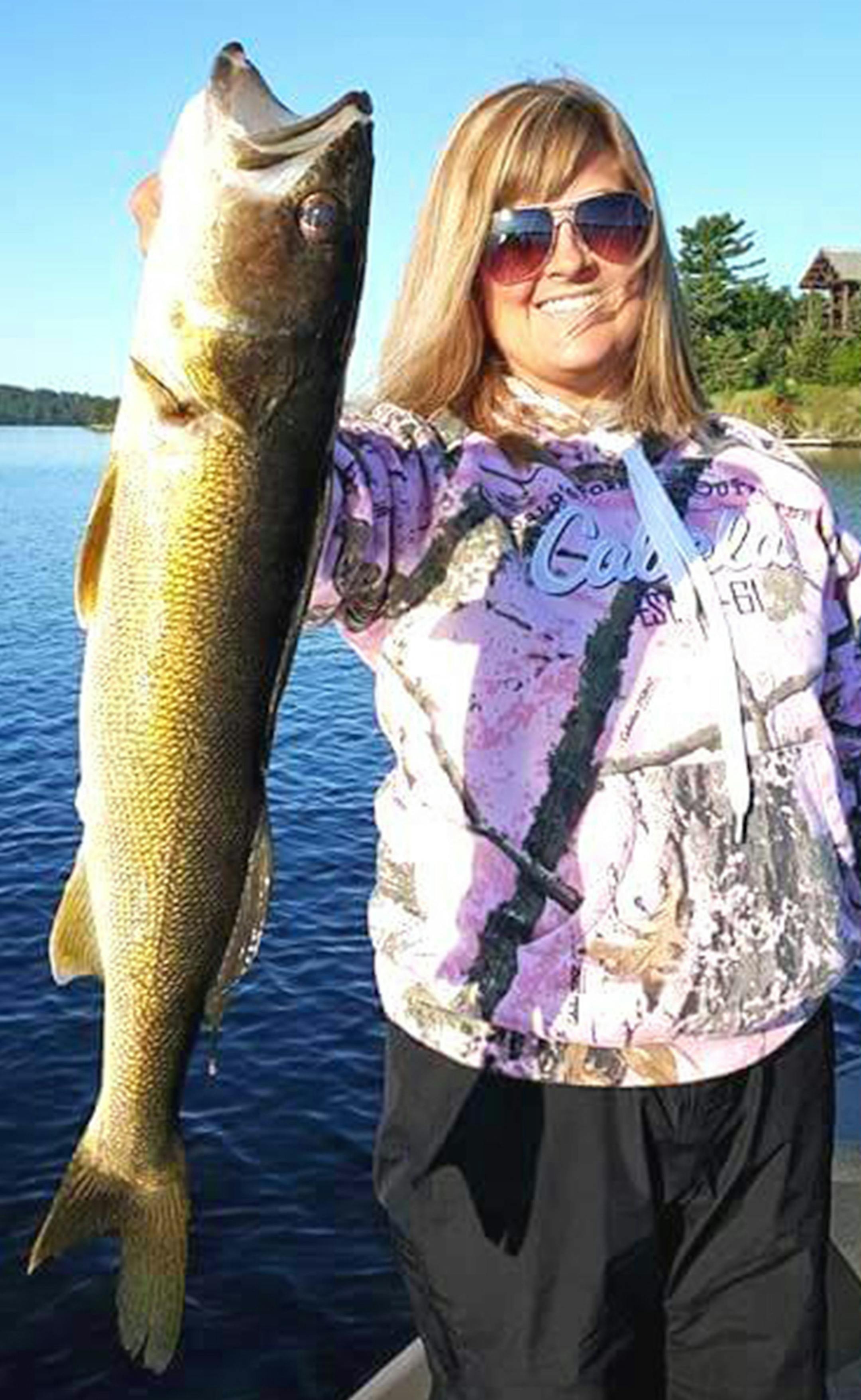 FATHER'S DAY GIFT Megan Kelly of Buffalo caught this dandy walleye on Lake Vermilion. ìWe were Lindy-rigging with leeches when she caught her largest walleye ever, 26 inches with good girth, making for a beautiful memory,íí said her father, Tom Kelly. ìI like to think of it as my Fatherís Day gift. Although we released the walleye, the memories and photo will live on.íí