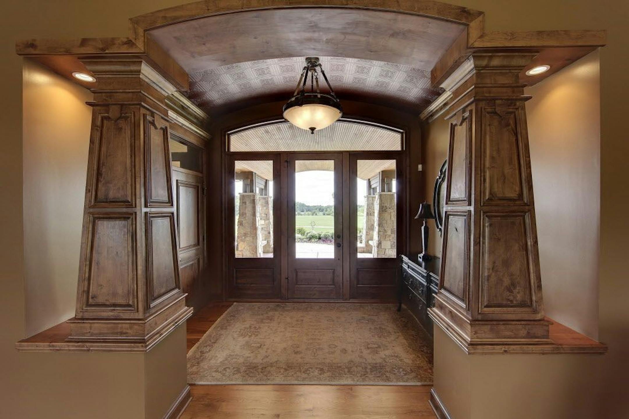 The front entry features pillars and other knotty alder woodwork.