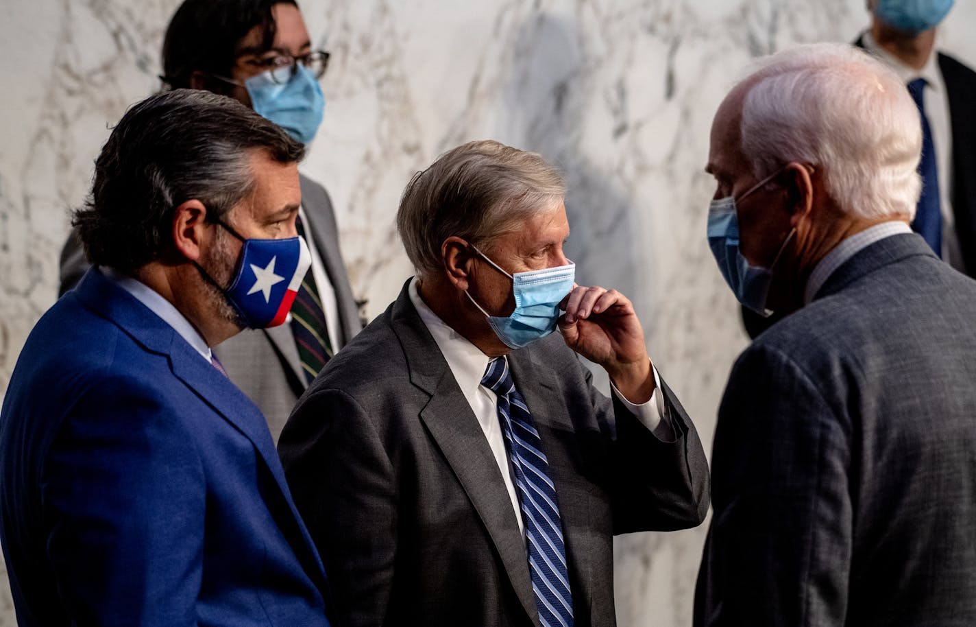 From left: Sens. Ted Cruz (R-Texas), Lindsey Graham (R-S.C.) and John Cornyn (R-Texas) during a break on the third day of hearings for Judge Amy Coney Barrett's nomination to the Supreme Court, in Washington, Oct. 14, 2020. Facing grim polling numbers and a flood of Democratic money and enthusiasm, Republicans on Capitol Hill are beginning to publicly put distance between themselves and President Donald Trump. (Hilary Swift/The New York Times)